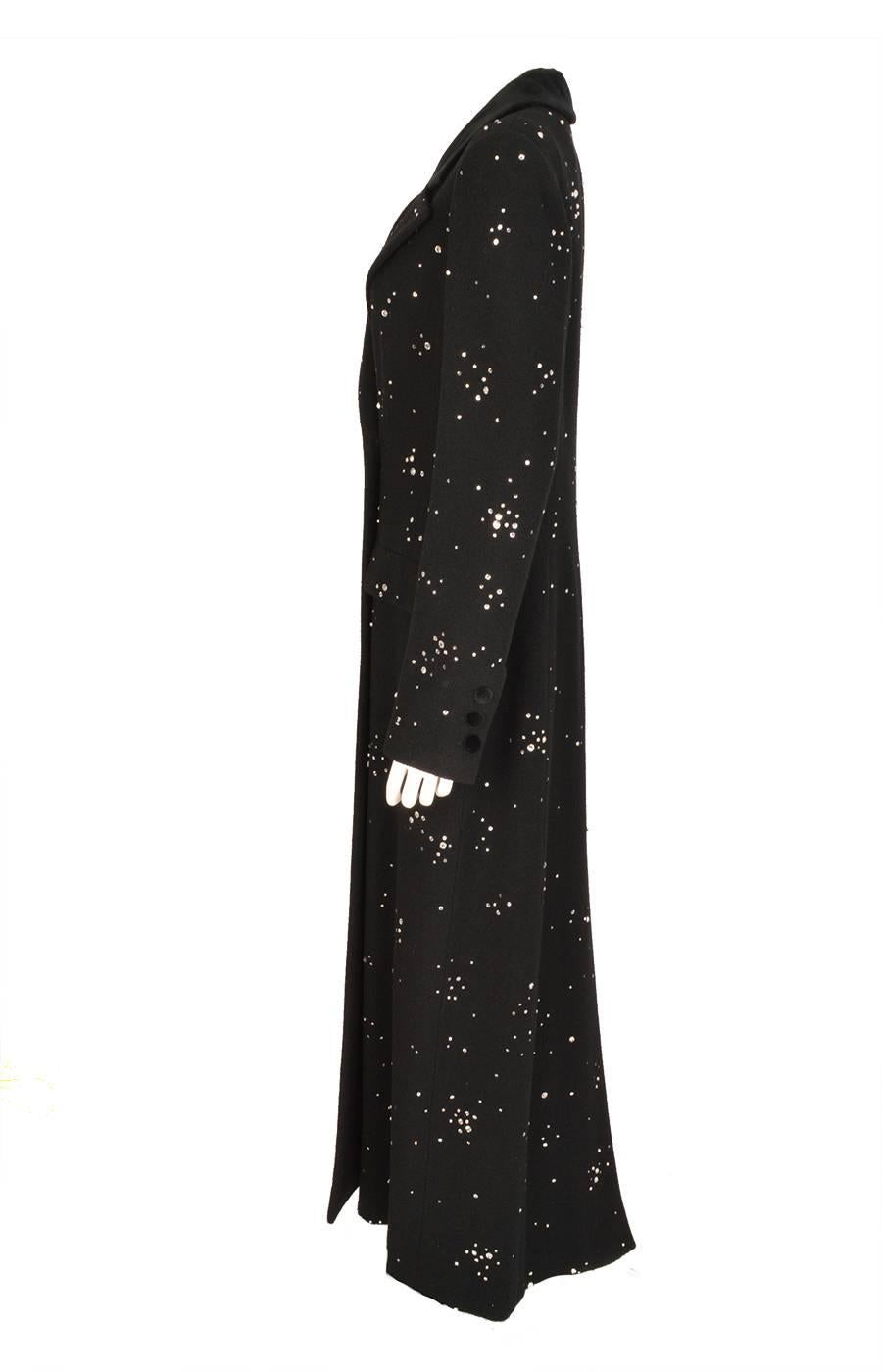 This elegant Chanel double breasted black evening coat in a wool and cashmere blend, sparkles from head to toe with over 1000 hand embroidered multi faceted Swarovski crystals and silver colored beads in various sizes. From the 2006 Fall collection.