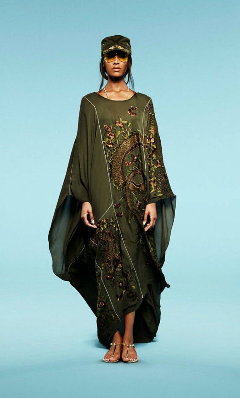 Emilio Pucci Asian inspired oversized silk caftan.    Fashioned of military green silk crepe with round neckline, long sleeves, hand embroidery with beaded detailing.   Stunning throw on fashion caftan that is chic comfy and consistently a show