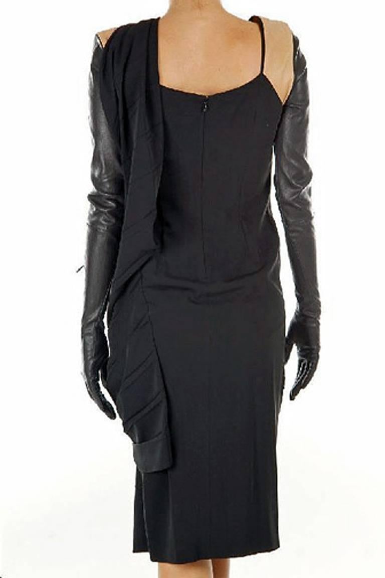 Martin Margiela dress fashioned of black silk crepe with soft lambskin saddle color leather at shoulders with attached black leather zipper long gloves. Asymmetricallyl draped and pleated around torso. Dress can be worn in 2 ways (see photos).