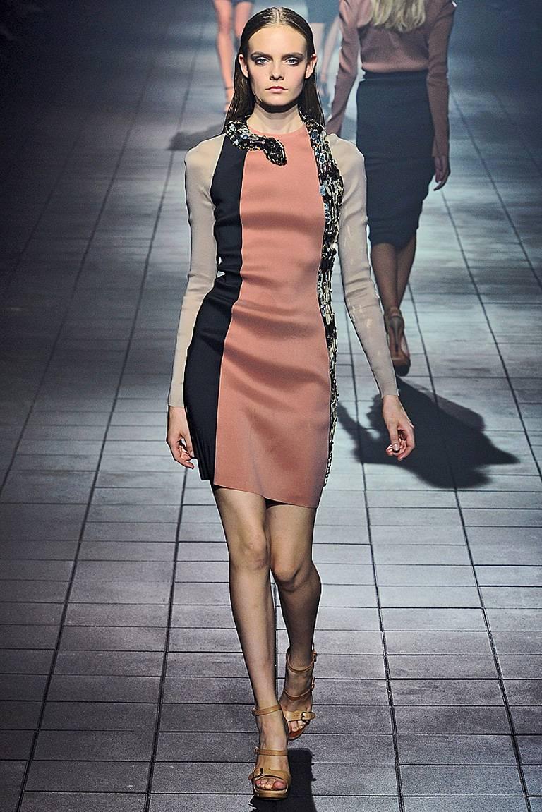 Lanvin 2012 mirrored serpent dress as seen on the runway and also worn by Jennifer Lopez.

Body hugging style fashioned of wool, silk and poly stretch in colorblock shades of black, camel and beige.   Fabulous handsewn mirrored oblong hexagons with