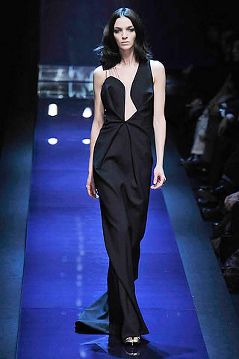 Ferragamo's plunge neckline asymmetric bias cut dress was the finale gown of the 2008 collection.  Fashioned of fine Italian black wool, lined with side zipper closure.  Boasts silver metal suture entwined with cobweb threads.  One of the best
