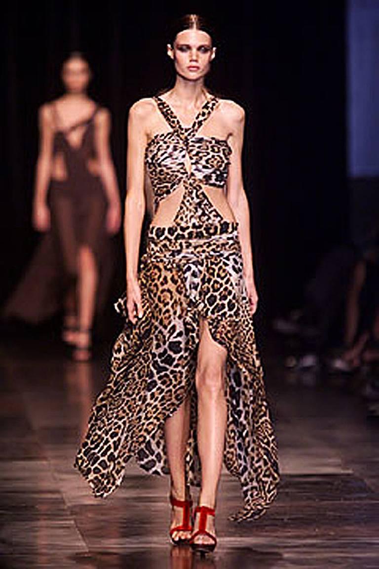 Rare YSL by Tom Ford leopard silk chiffon dress featured on the
runway and twice in the Tom Ford Book. Photo of Renee Zellweiger in book.

Designed like an asymmetric jigsaw puzzle that wraps and ties;  uneven hemline. Features attached silk