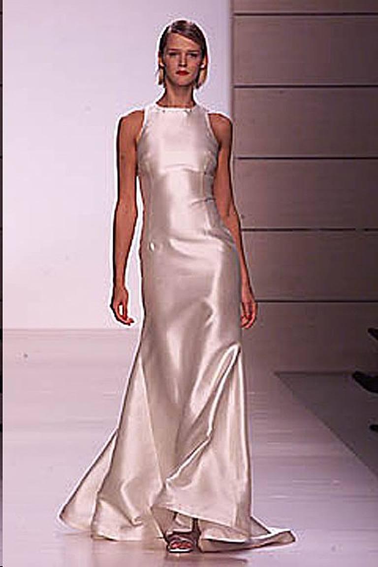 Valentino high fashion stunner from one of the designer's most exciting and sold out collections of 2001. Sleeveless racer back gown fashioned of off white shantung silk. Criss-cross double strap back adorned with clear Swarovski crystal adjustable