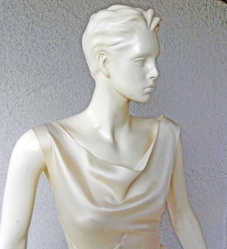 Circa 1990's John Galliano for House of Dior asymmetric bias cut gown.  Sleeveless cowl neckline with asymmetric treatment at hip.  Fashioned of off white weighty hammered silk. Zipper closure; lined. 

Measurements:  bust: to 33