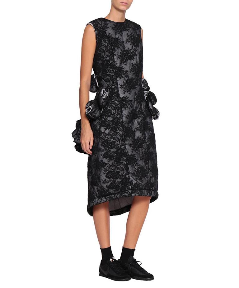 Comme des Garcons black padded floral lace dress adorned with raw edges.  Zip closure at back. Composition: 65% cotton 35% nylon    From the collection of  