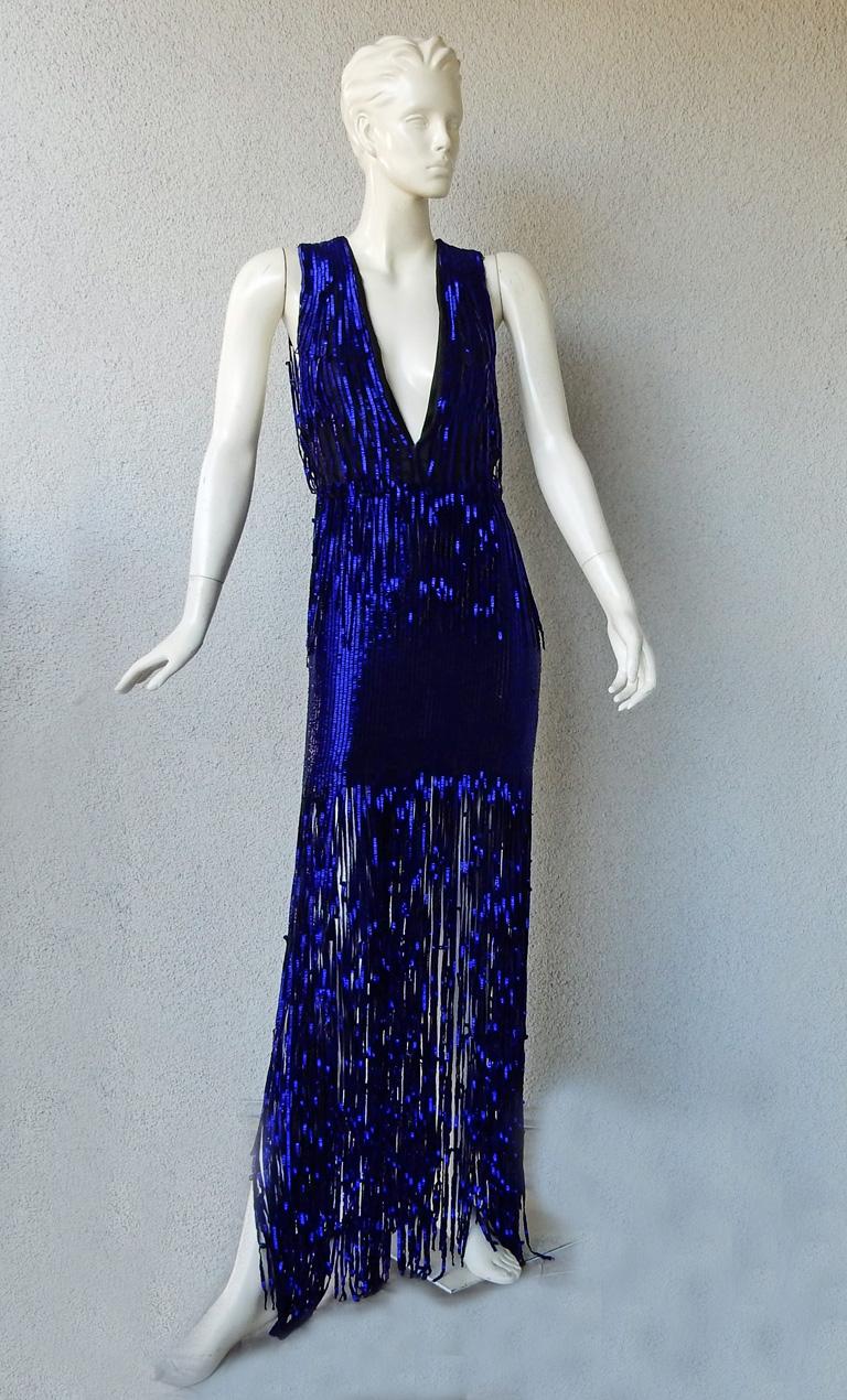 Brand new Tom Ford deco inspired hand beaded evening dress.   Boasts rich beautiful cobalt blue bugle beads all hand sewn atop black silk organza extending down to skirt featuring open work fringe to showcasing lots of leg.   Dress is 1 piece with