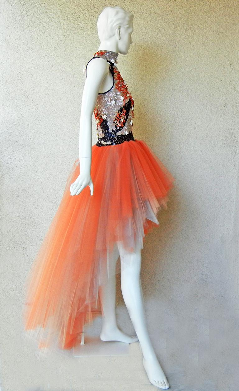 Rare 1970's Valentino high low evening dress a style of which very few were produced.   Bodice displays Valentino's superb beaded handwork of hanging shells, coral, and seed beads. Black satin trim at neckline and armholes.    Ombre tangerine tulle