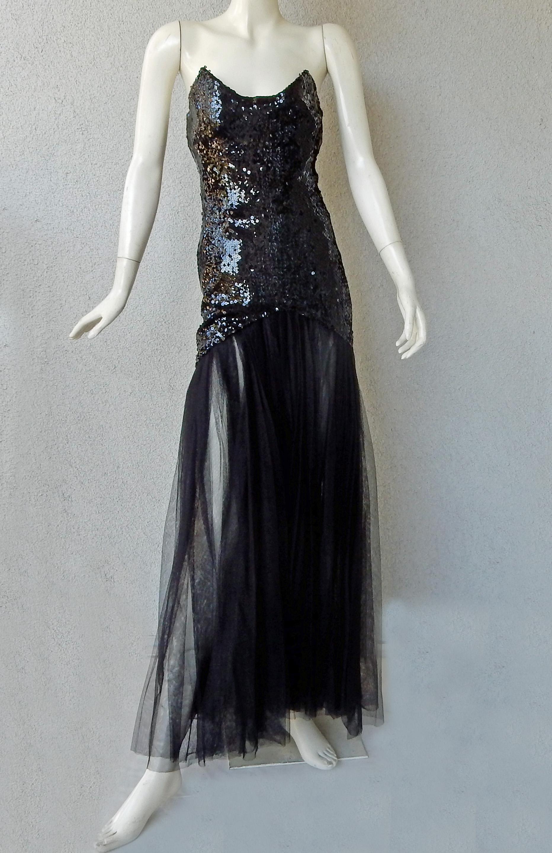 Rare mid 90's Thierry Mugler strapless mermaid style evening gown with elongated bodice of handsewn black paillettes and skirt fashioned of layers of black chiffon.  Lined.  A very dramatic look and the essence of the designer's work. Fully lined;