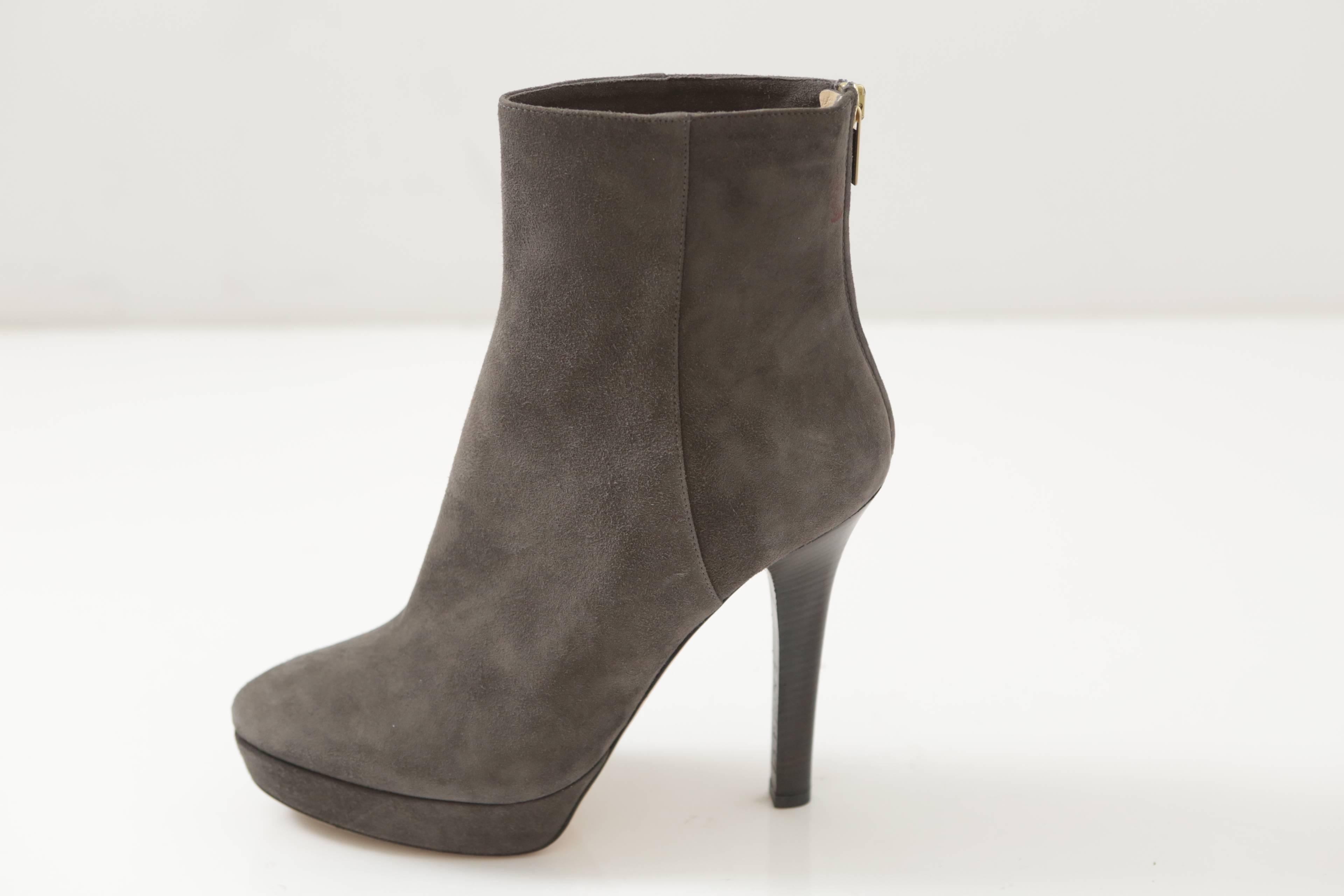 Classic ankle boot in grey suede with interior zip and gold hardware.