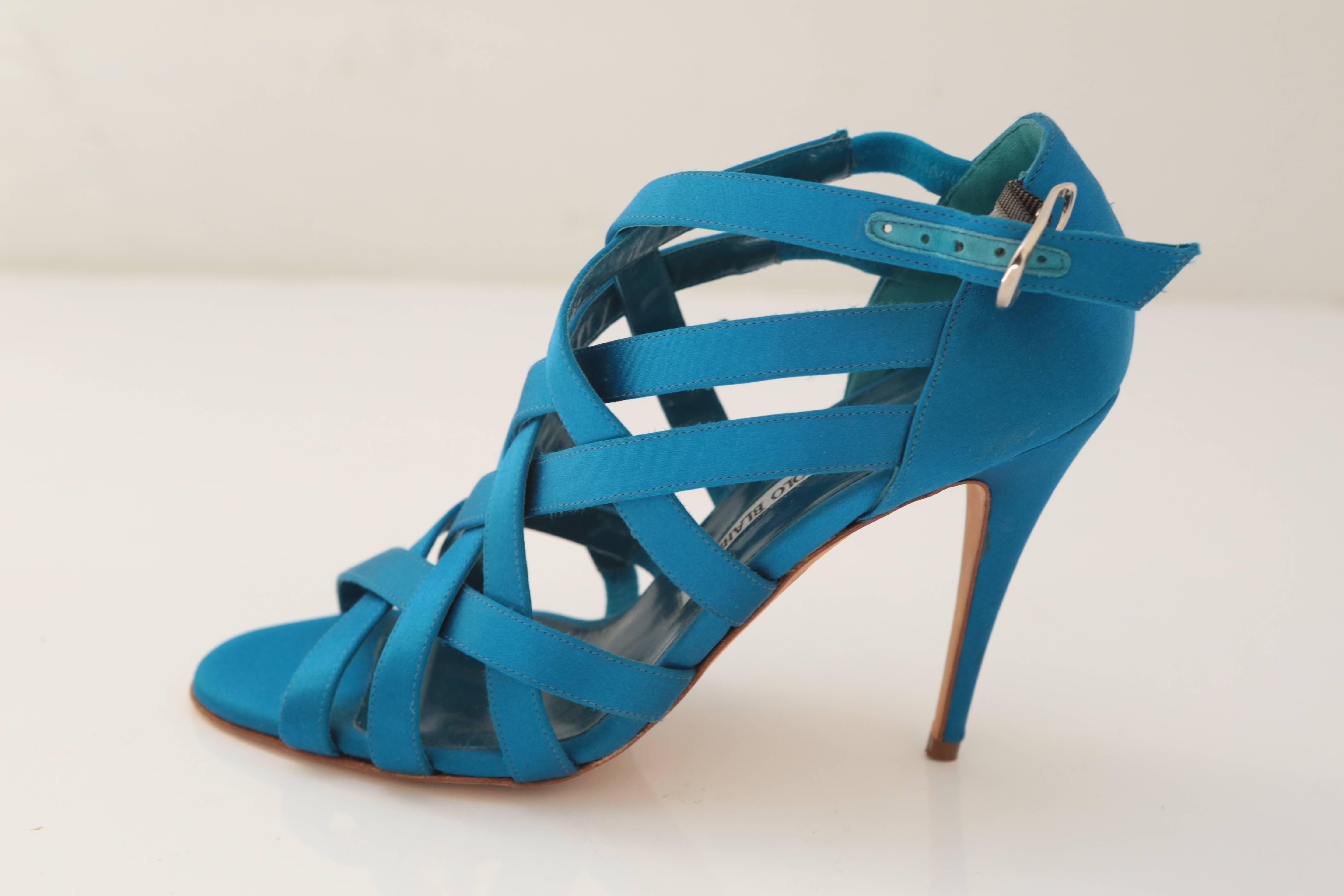 Strappy criss-cross heel in satin is the perfect shade of teal to dress down for daytime or jazz up for evening. A covetable classic from Manolo Blahnik.