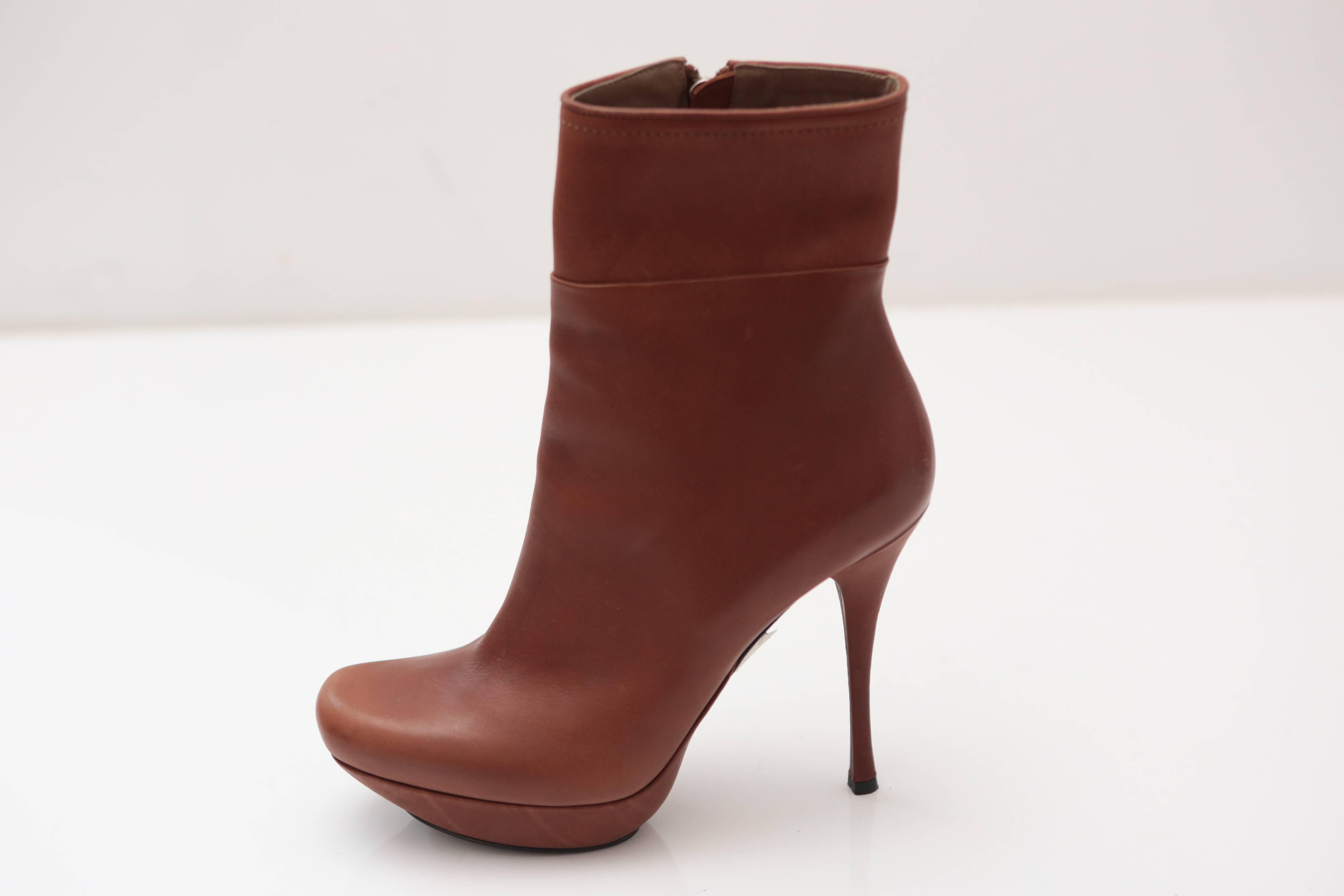 Classic soft brown leather heeled booties with interior full zipper in silver.