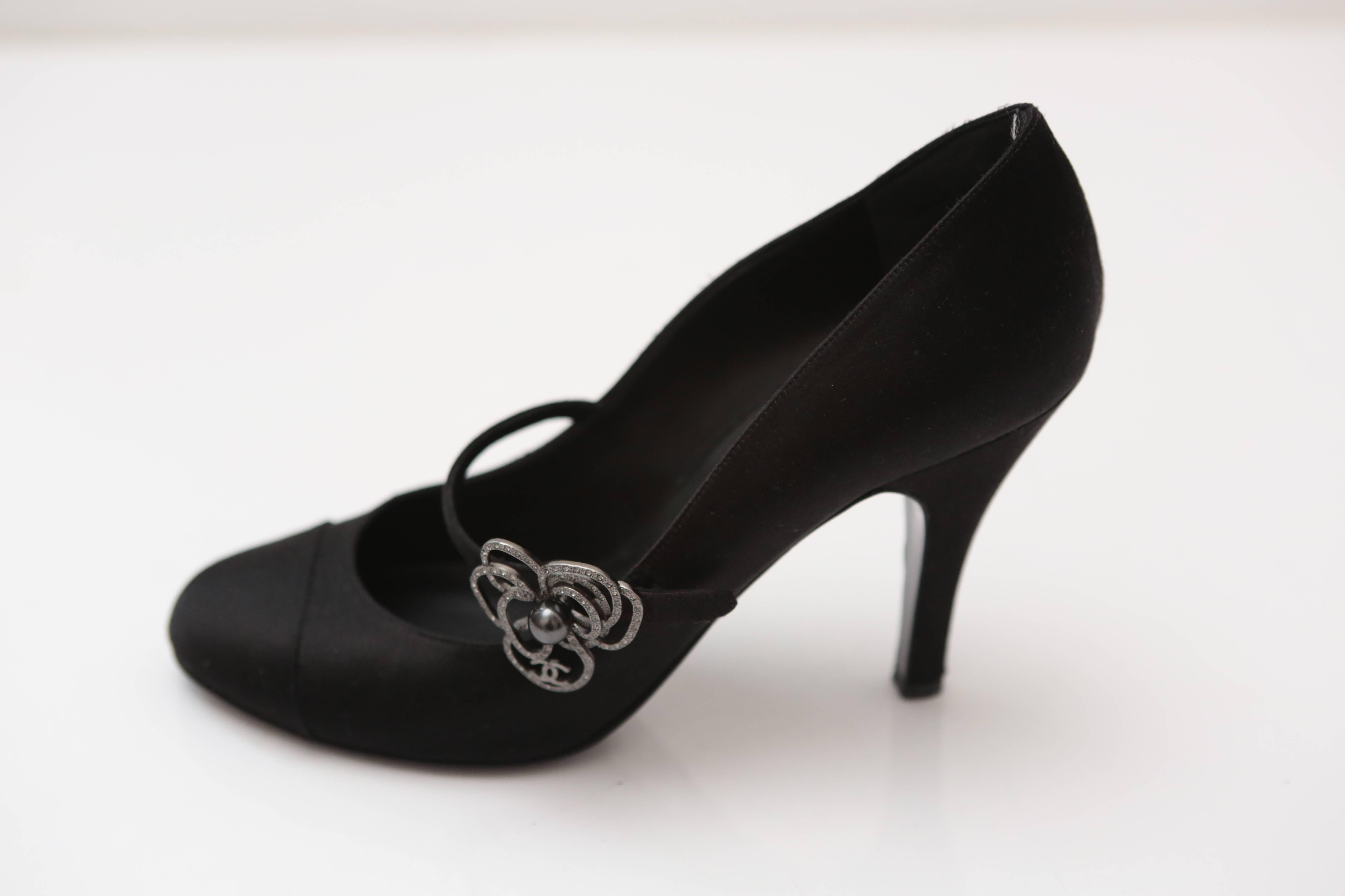 Silk Mary Jane with Camelia Flower detail in Crystal adorn this delicate evening shoe in the perfect mid-heel height. Perfect for a night out or just because.