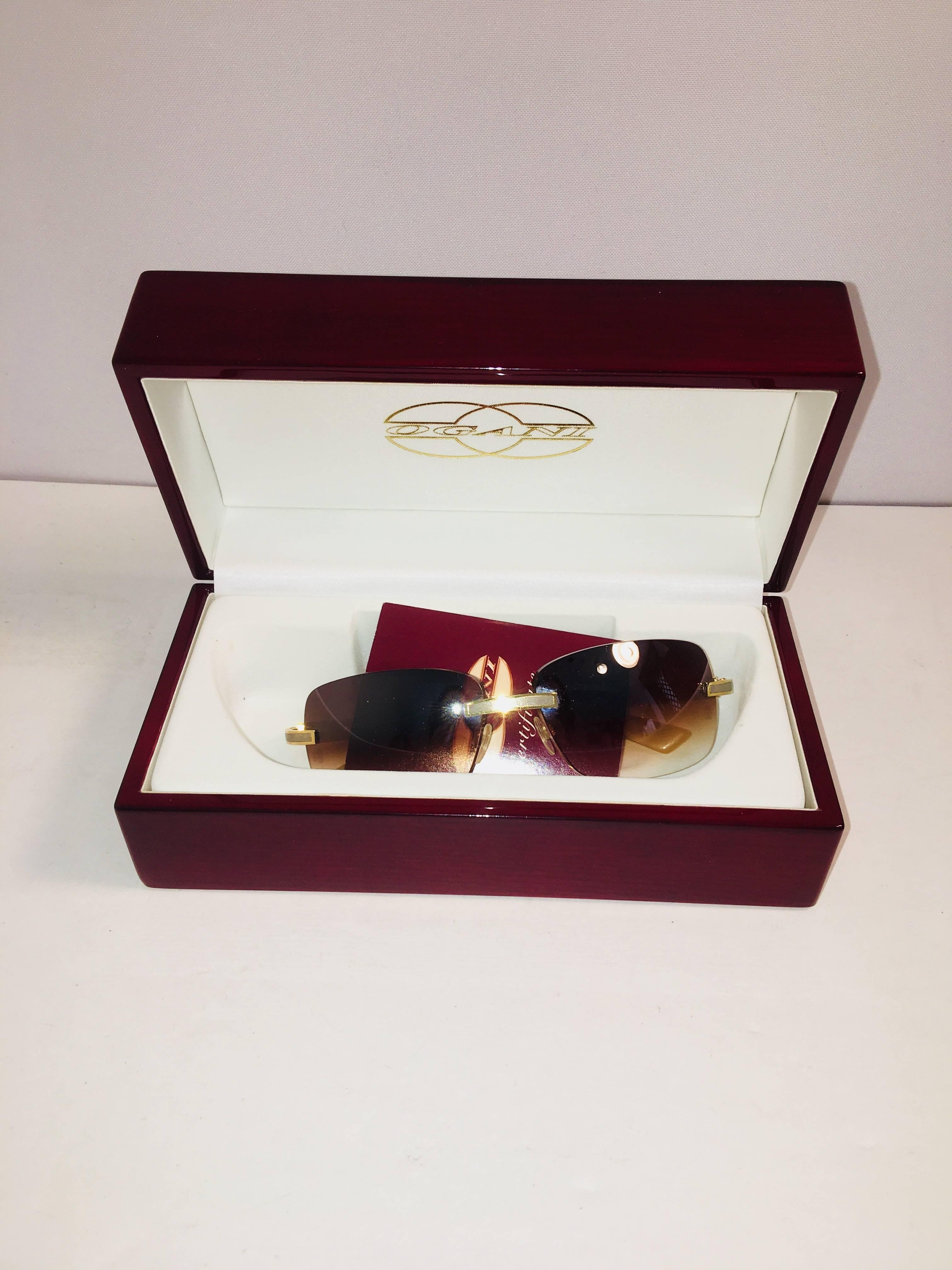 Small Rectangular Tinted Sunglasses with Original Box. Retails for $2000