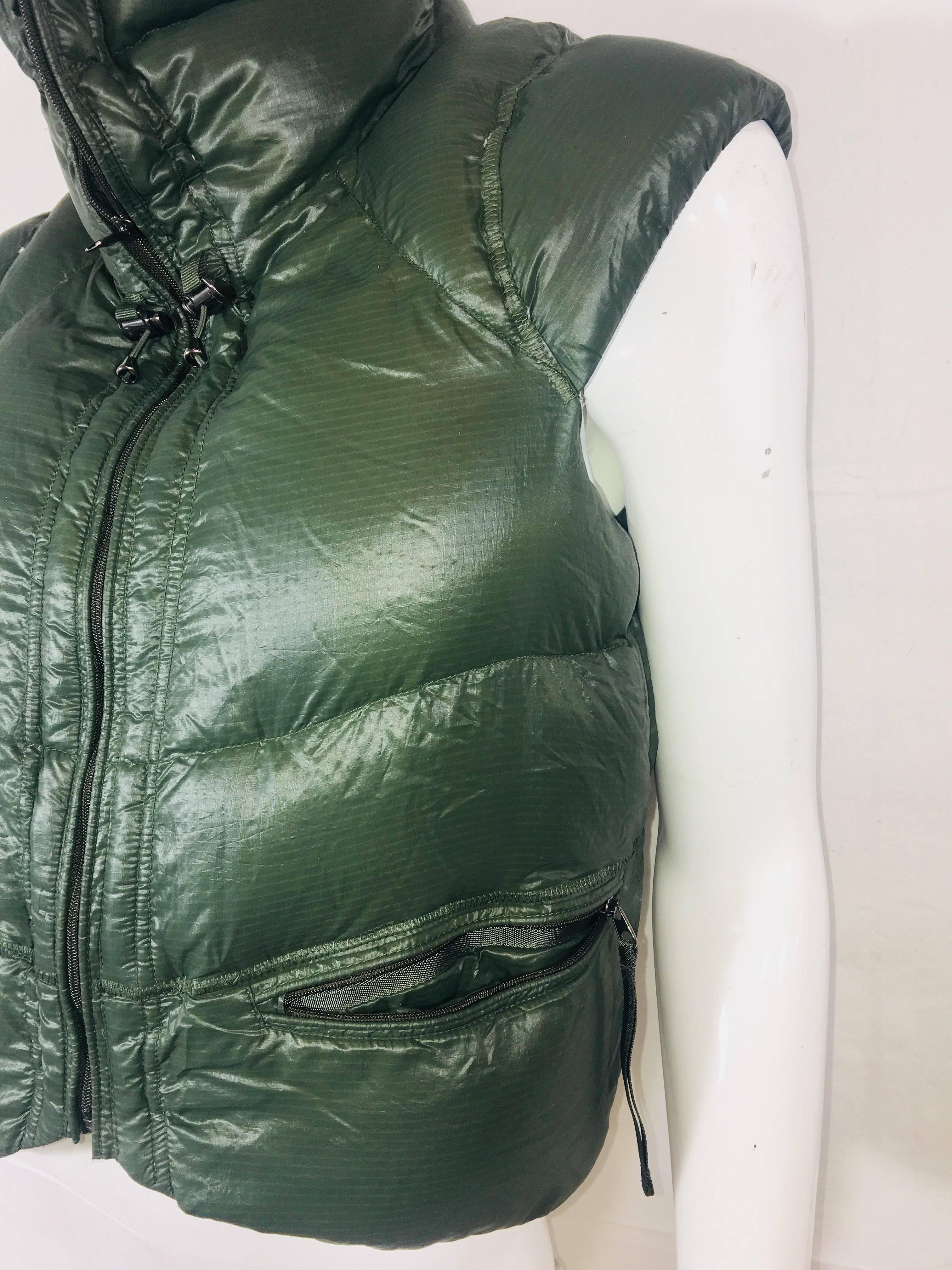 RLX Ralph Lauren Puffer Vest in Olive Nylon with Zip Front, Double Exterior Pockets, Inside Pocket and Drawstring Collar.