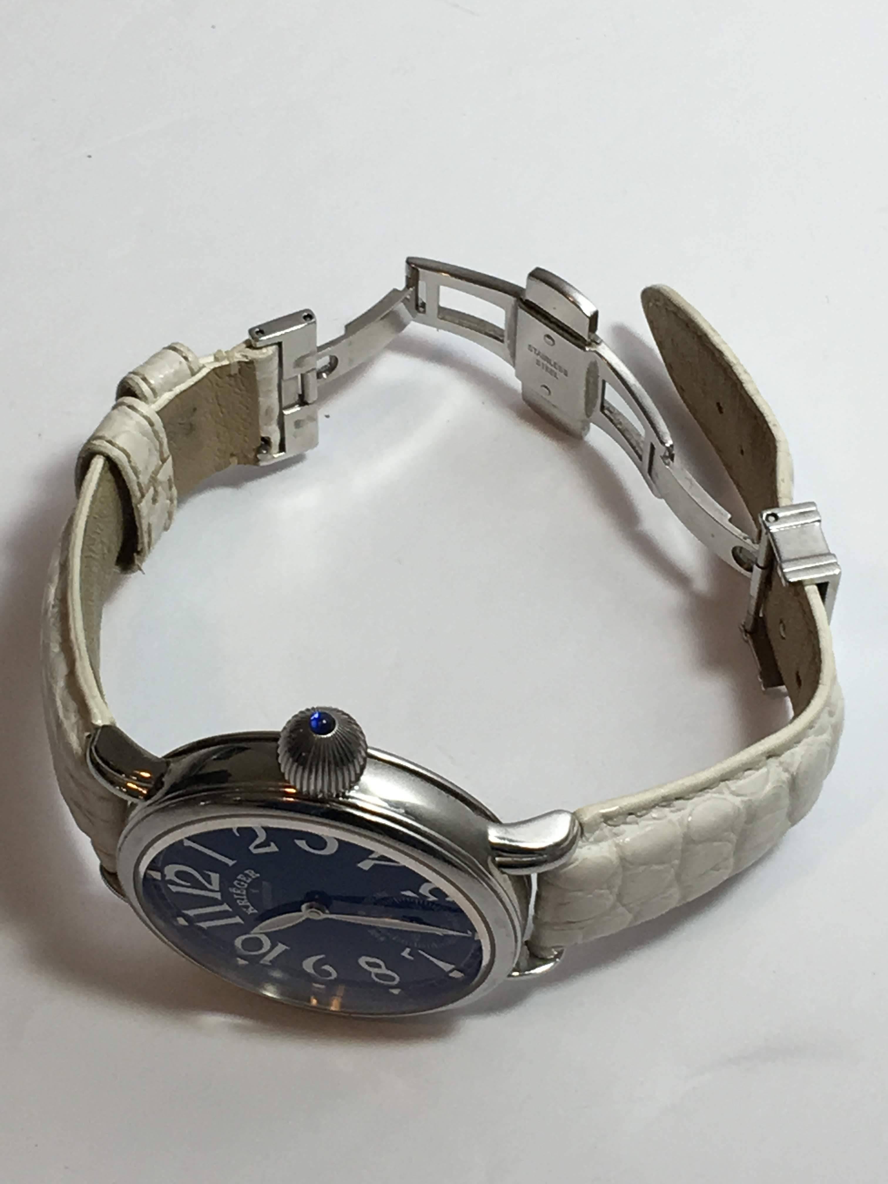 Round Blue-Face Dial Watch with White Crocodile Wrist Band, Silver Hardware. Exposed Dial at Back of Watch.