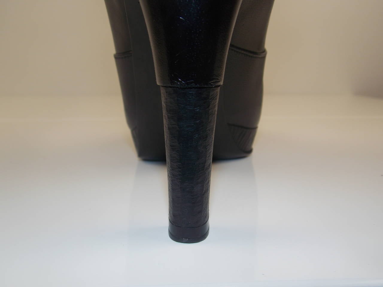 Black leather Chanel round-toe, slip on ankle boots with stitched CC logo at top sides.
Slight platform bootie, with 4