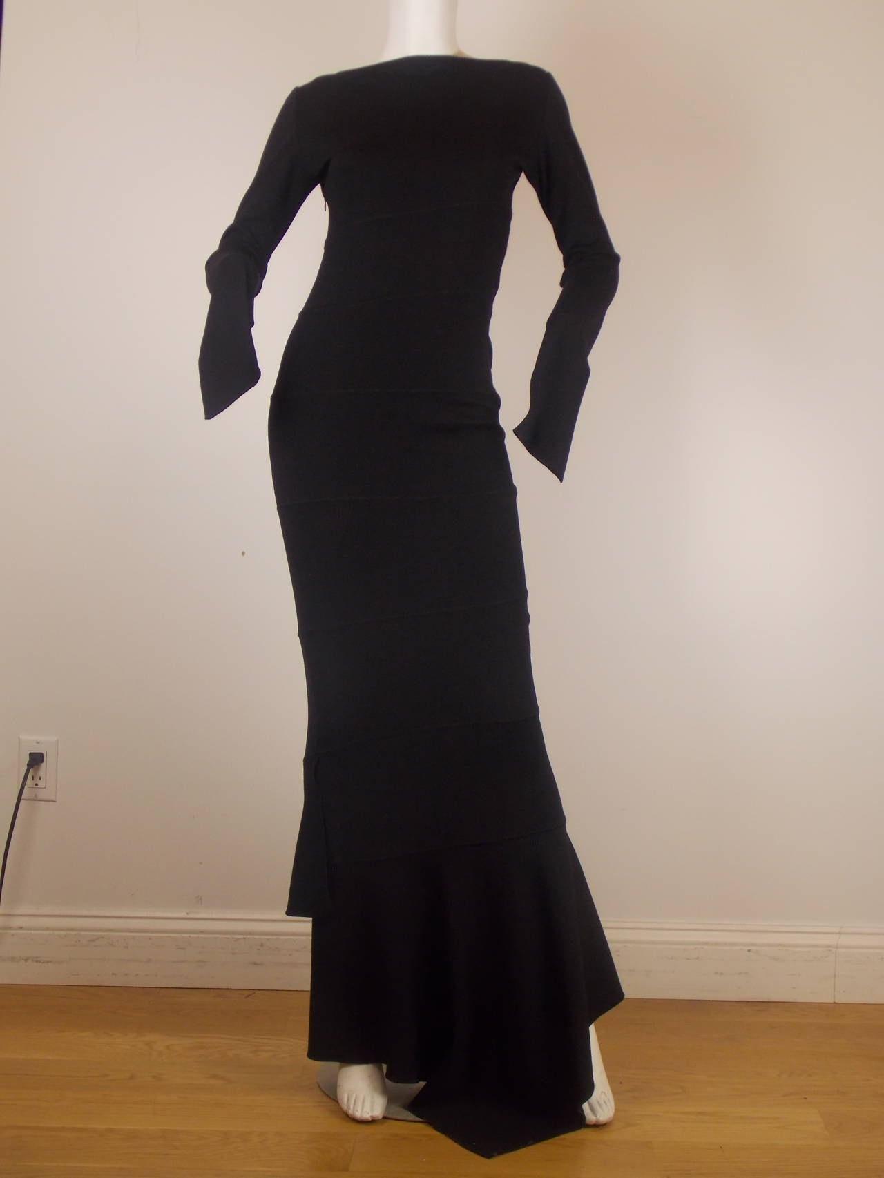 Paneled construction defines the figure-hugging silhouette of this authentic vintage Alaïa dress. Minimalist profile with wide neckline and long sleeves. Invisible zip closure at left side. Unlined.
Mid-weight fine wool knit. 100%Lana virgin new