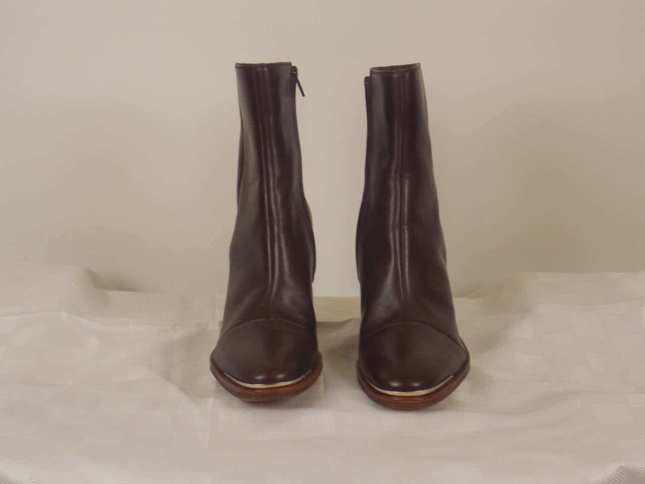 Celine brown leather ankle booties with 1 inch wood heel, and side zip closure.