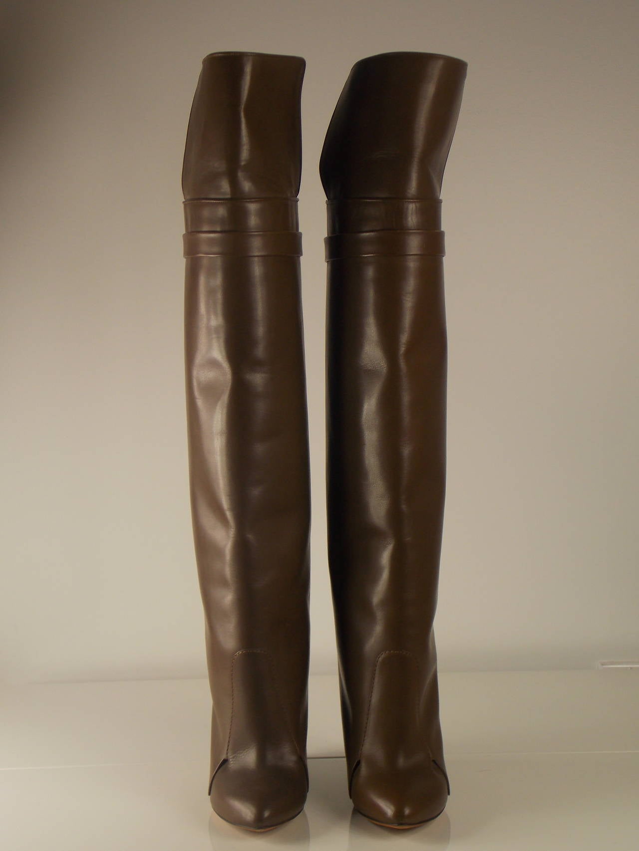 Authentic GiVENCHY knee boots.  Leather-covered and lacquered wood-effect wedge heel measures approximately 115mm / 4.5 inches, Brown leather (Calf), Mocha overlay with extended front panel and strap around top, pointed toe.