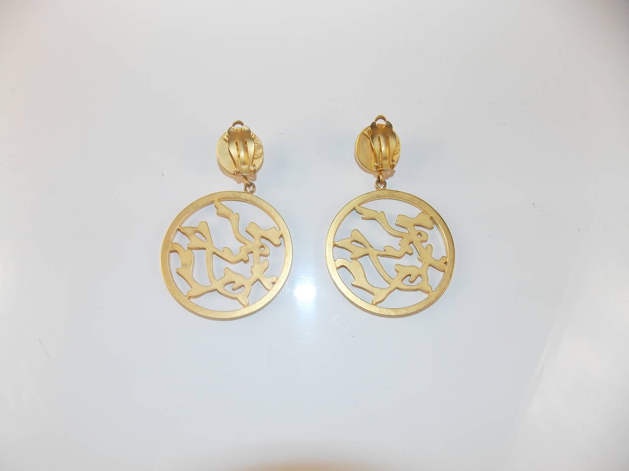 Karl Lagerfeld gold resin turquoise cabochon clip earrings with stunning branch detail in circle drop.