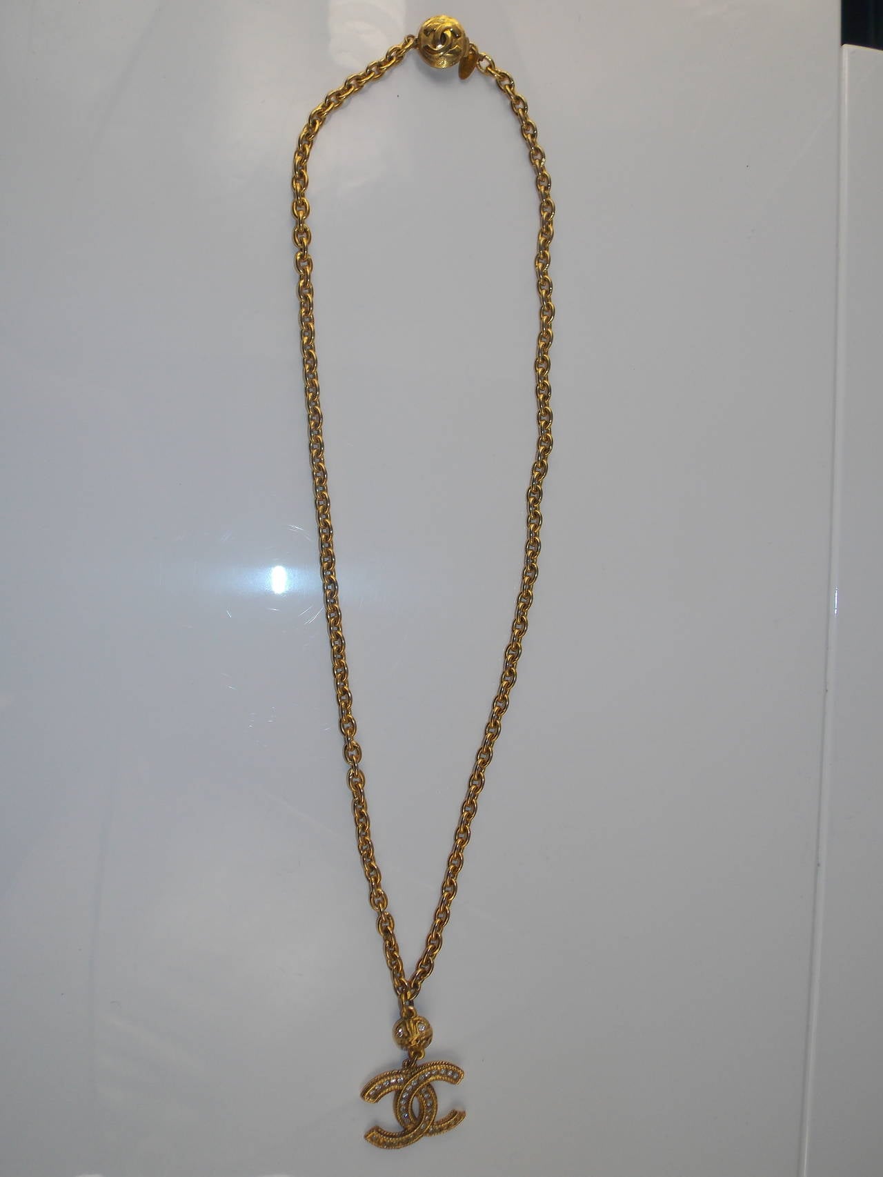 Chanel gold chain rope necklace with crystal CC logo pendant.