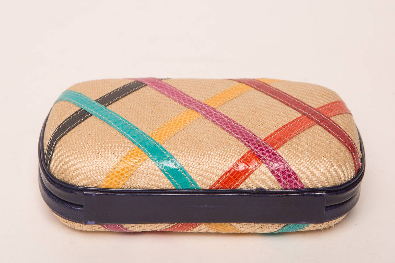 Bottega Venetta straw colored clutch with multi color design.