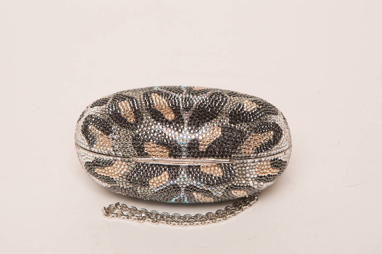 Judith Leiber leopard crystal clutch with silver chain strap.