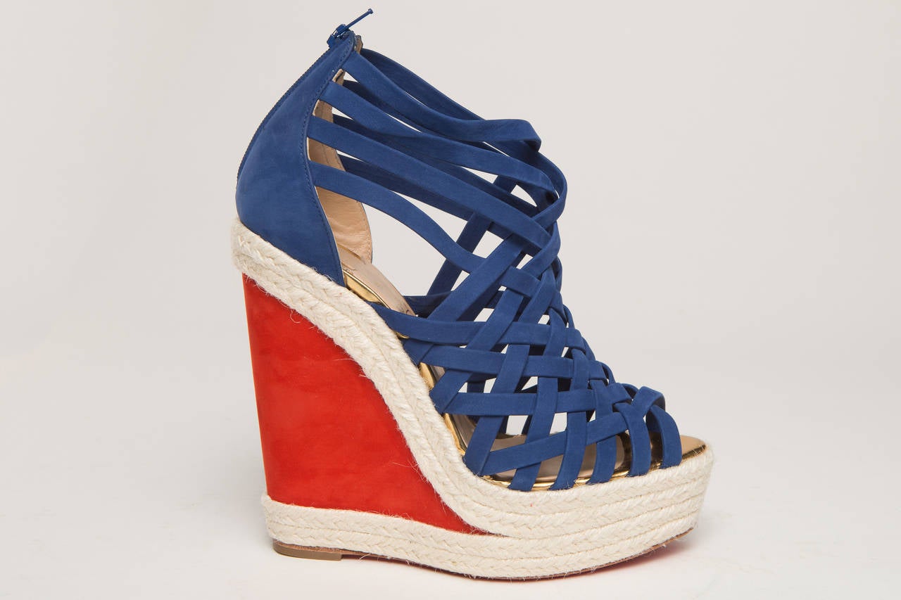 Christian Louboutin blue espadrilles with red wedge heel.