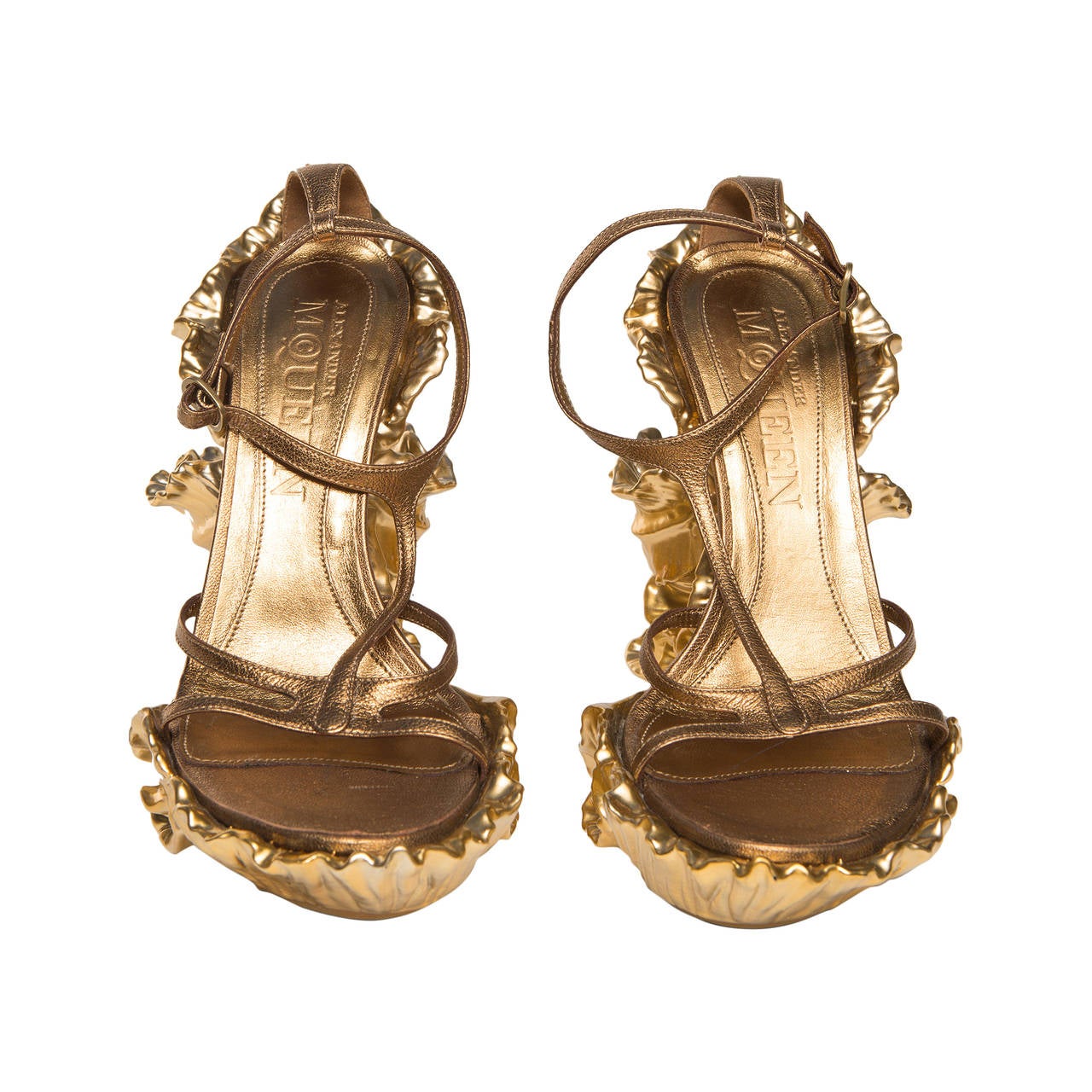 Alexander McQueen  sculpted gold shoes with wedge heel.