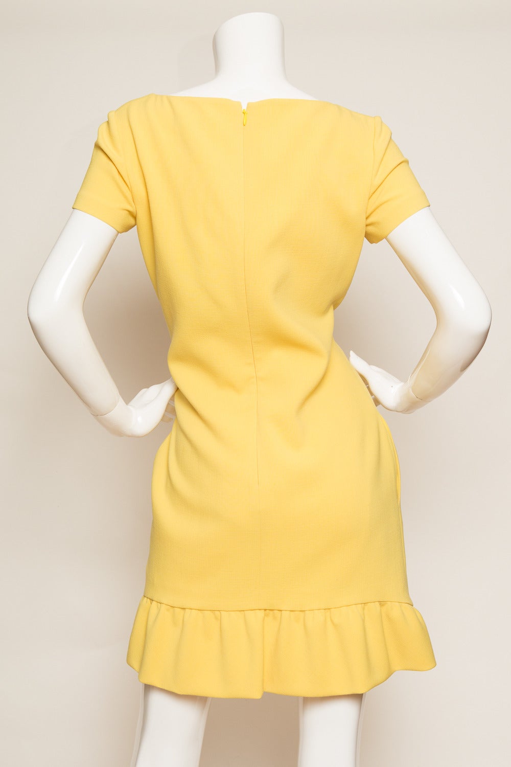 Yellow shift cap sleeve dress with ruffled hem.