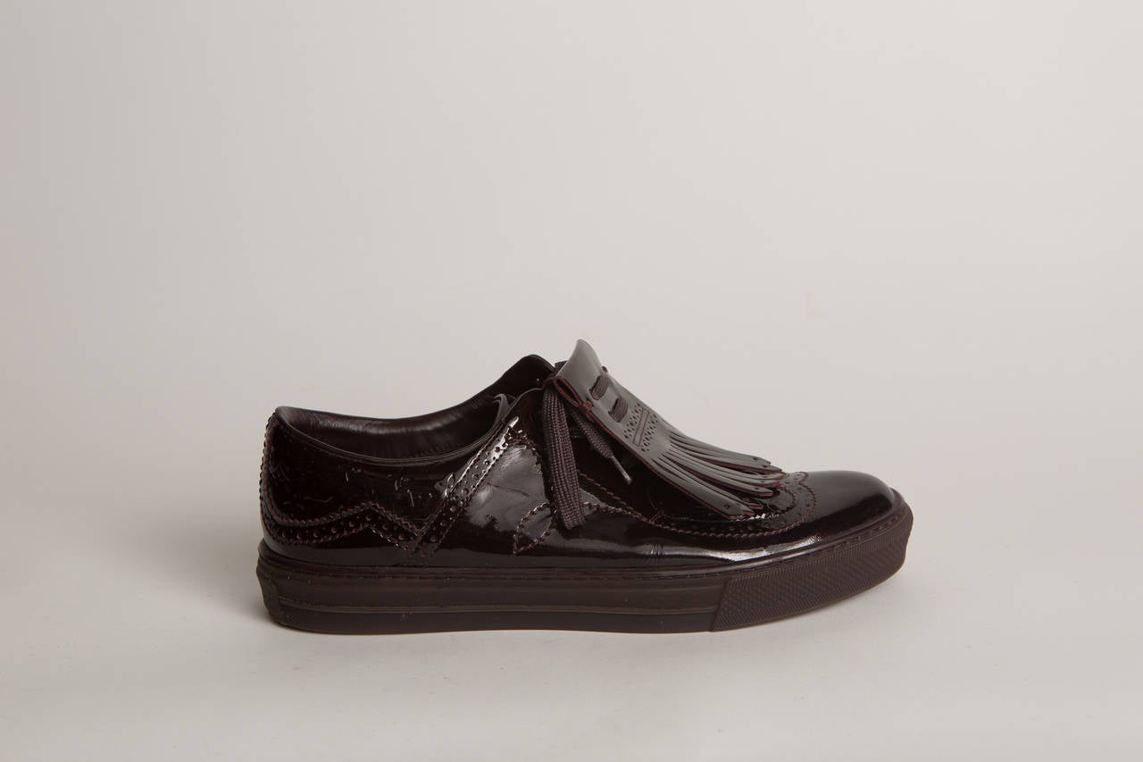 Louis Vuitton aubergine patent leather brogue style sneakers.
Never worn!