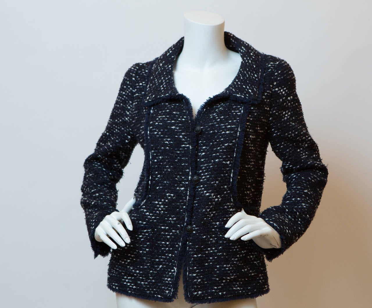Chanel black and white tweed wool blend single breasted blazer with front pockets, and zip closure detail on sleeves. 
ID: P24793V15089