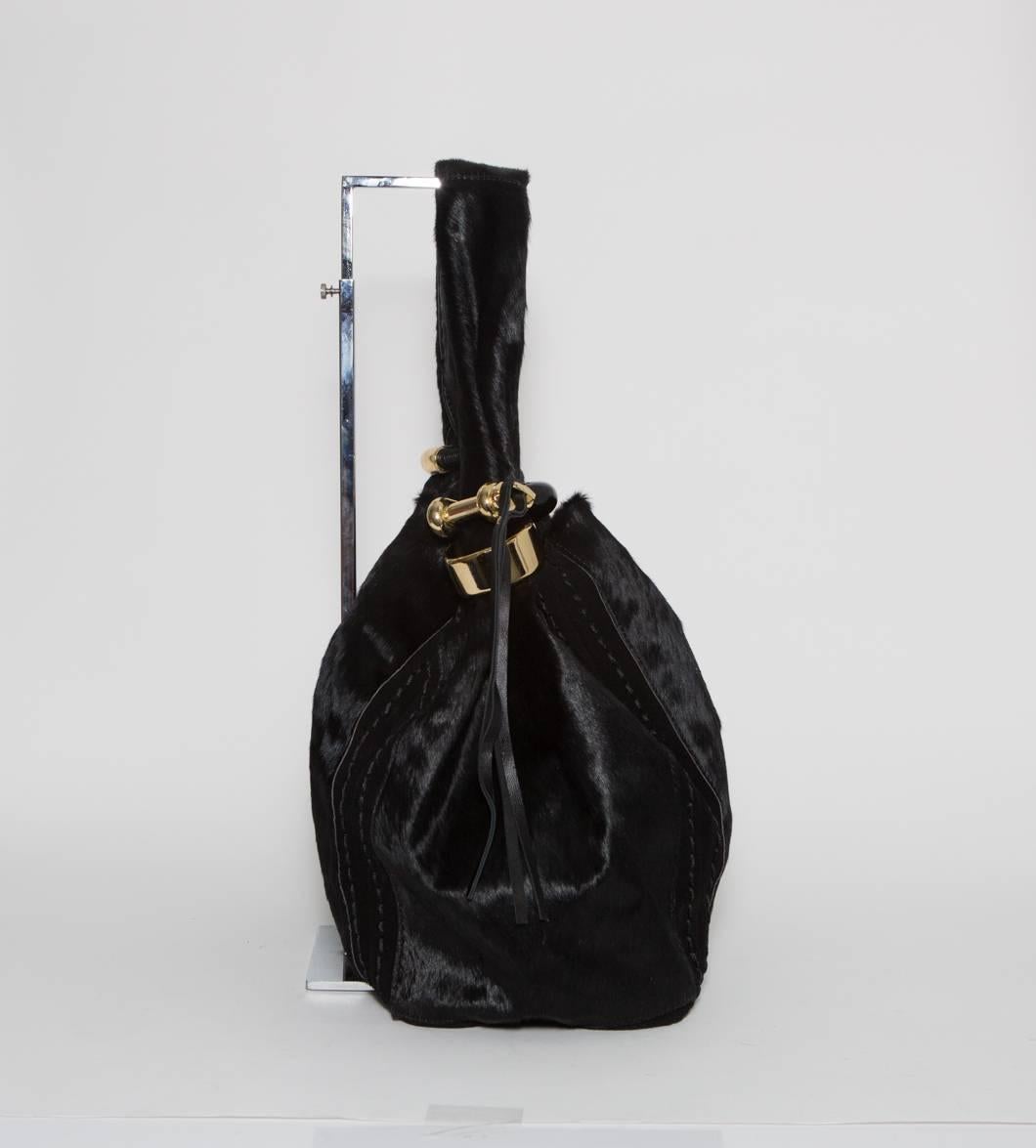 Black pony hair hobo bag with gold hardware.