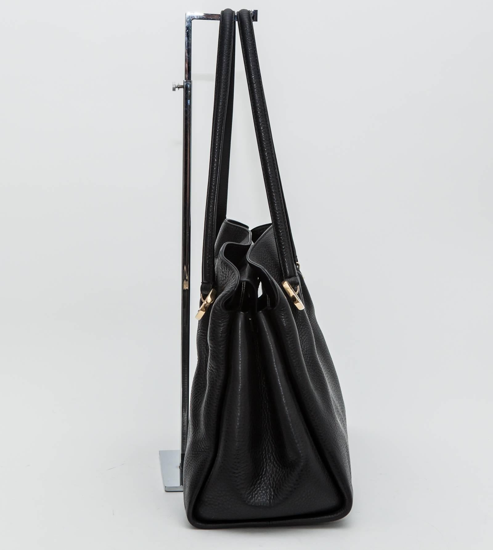 Black leather top handle shoulder bag with Bulagri gold hardware. Triple inside sections with inner pockets.