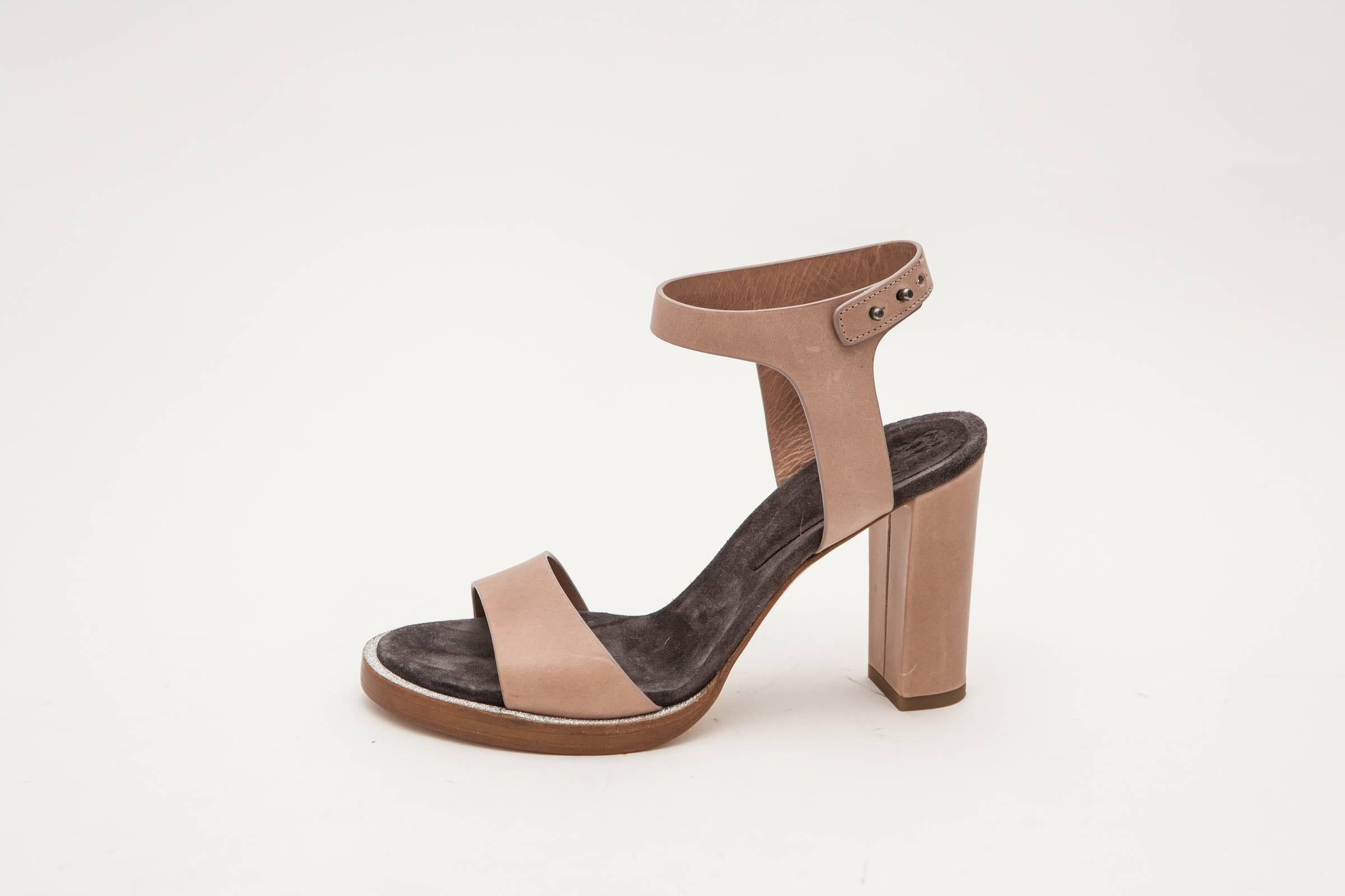 Tan sandals with 3 inch heel, ankle strap and silver rhinestone detail.