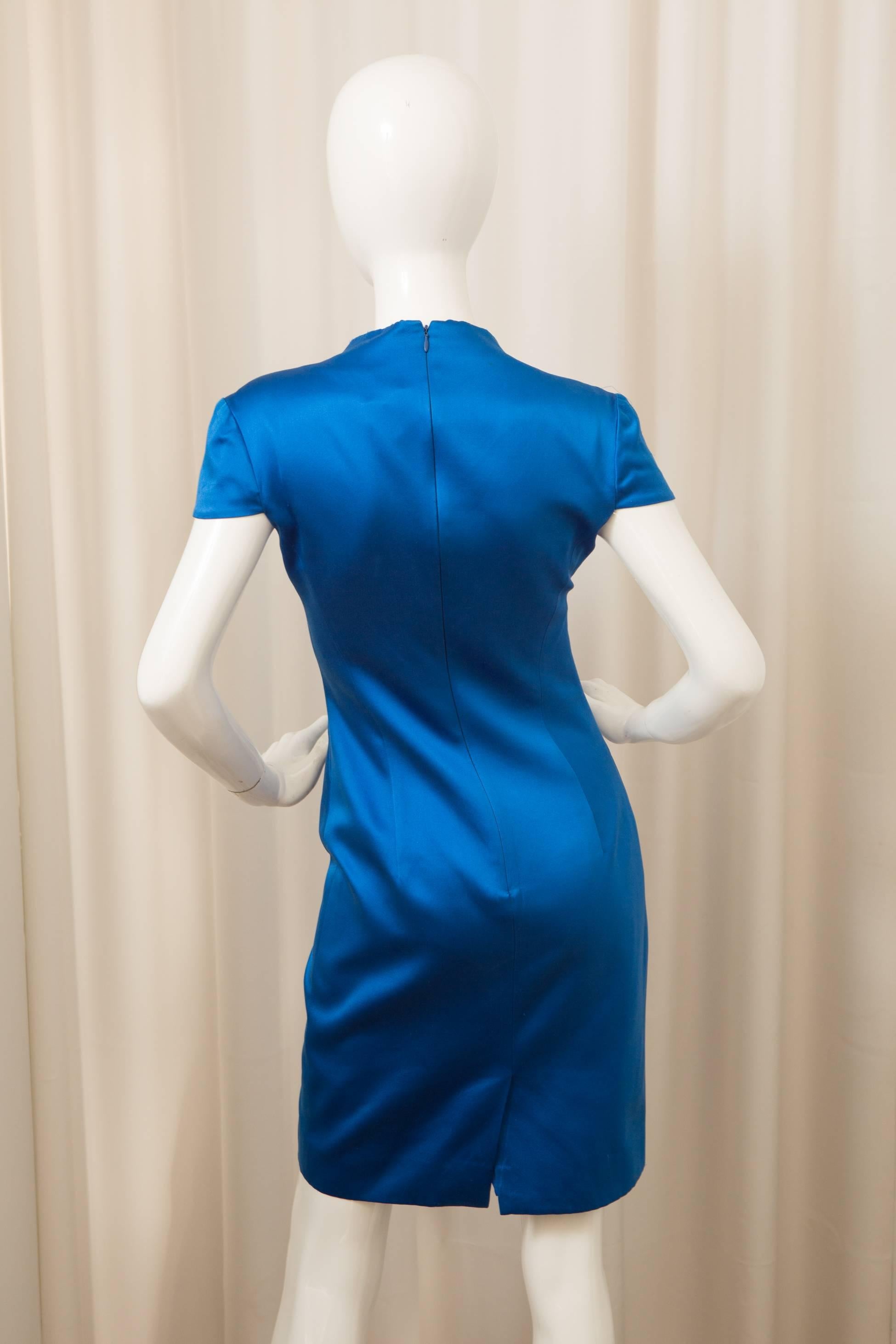 Short sleeve mid length dress w/ back slit and low neckline.