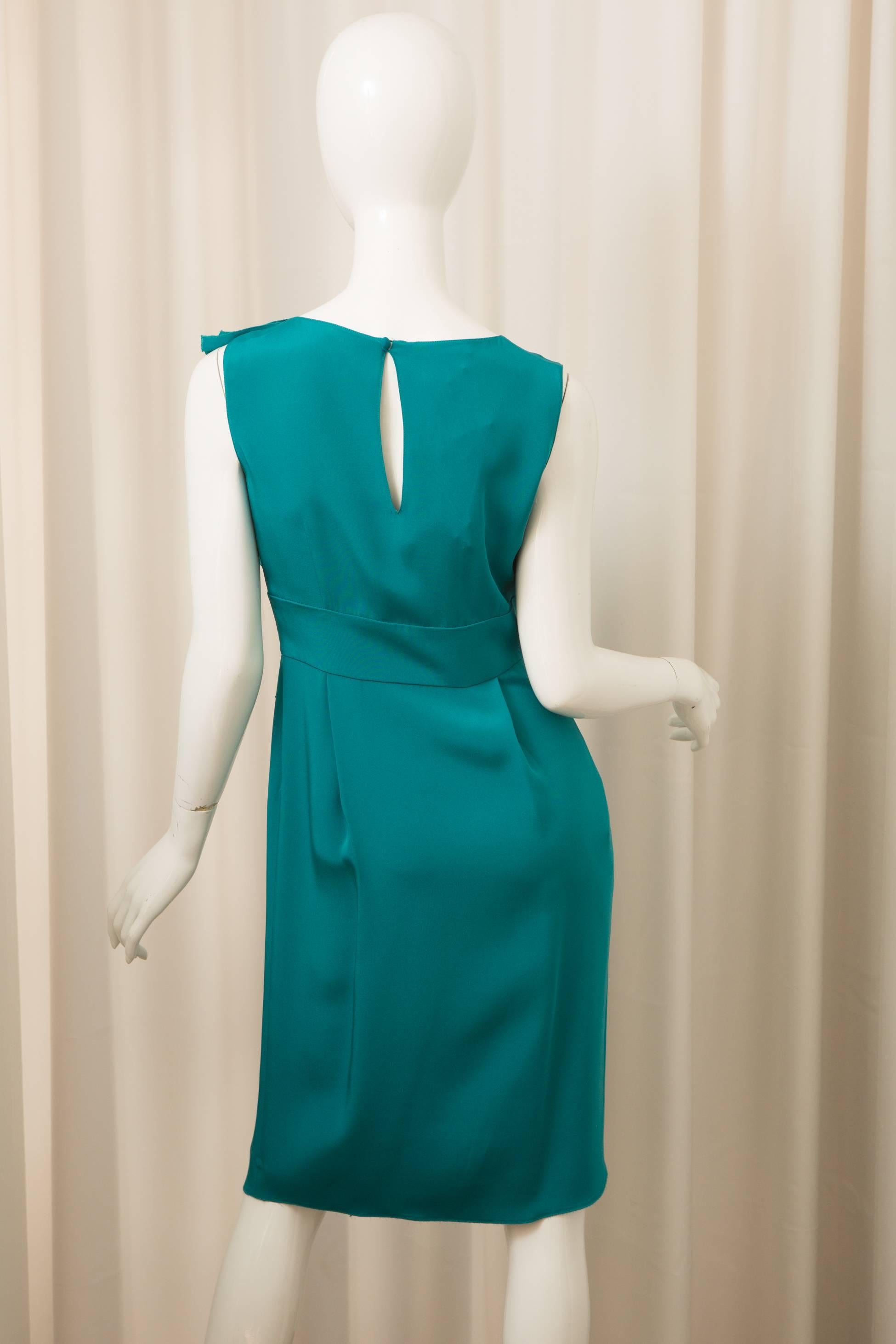 Teal Sleevless dress with front ruffle detail.