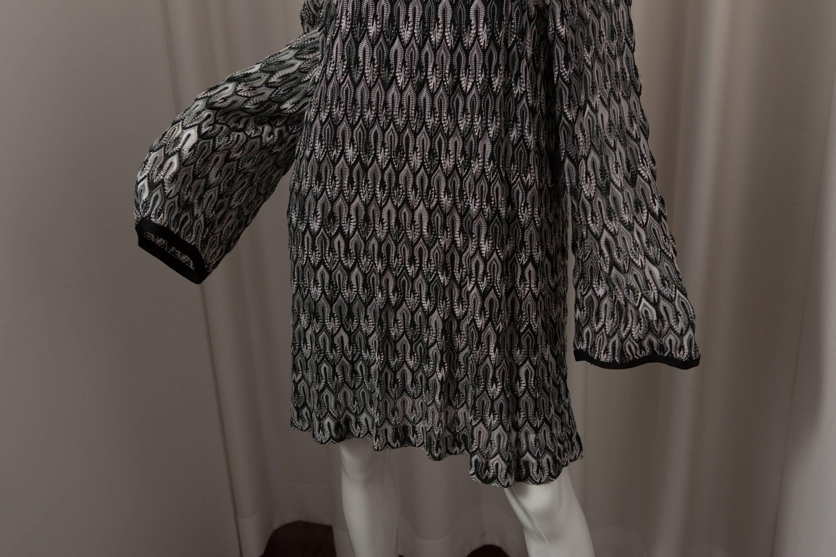 Rayon knit black and white shift dress with square neck detail.