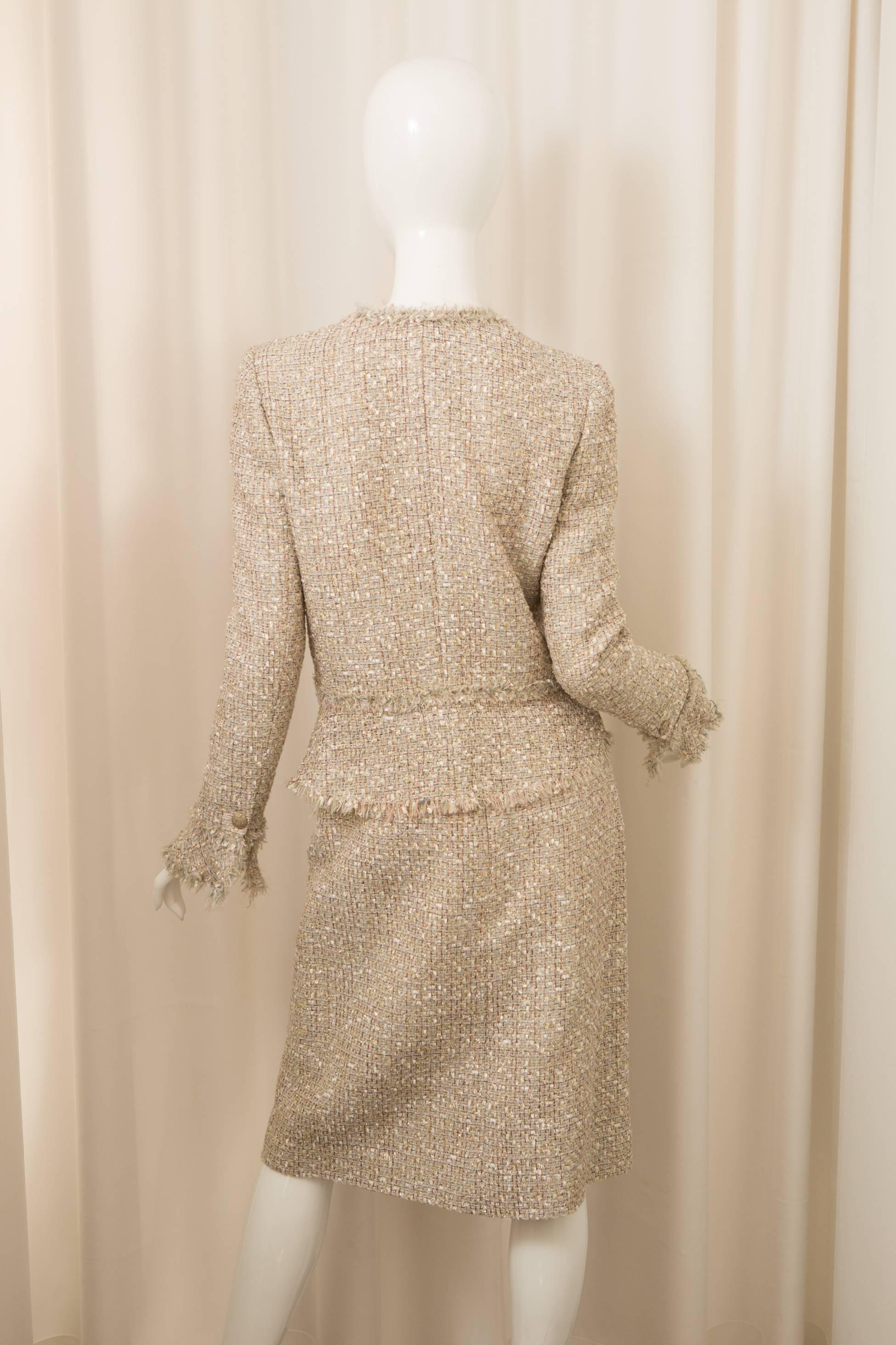 Chanel Two piece metallic skirt suit with bell sleeves in iconic Tweed with fringed edges. 
