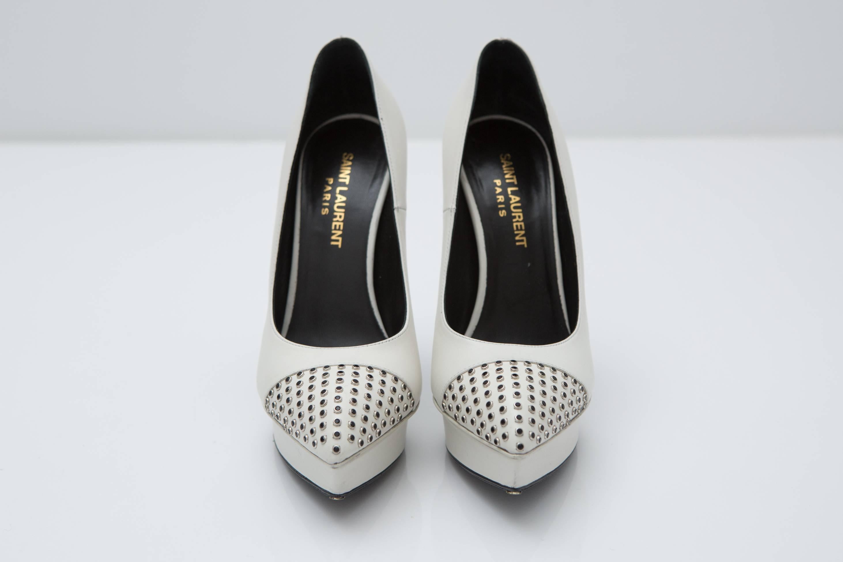 Ivory pointy toe pumps with metal stud detail.