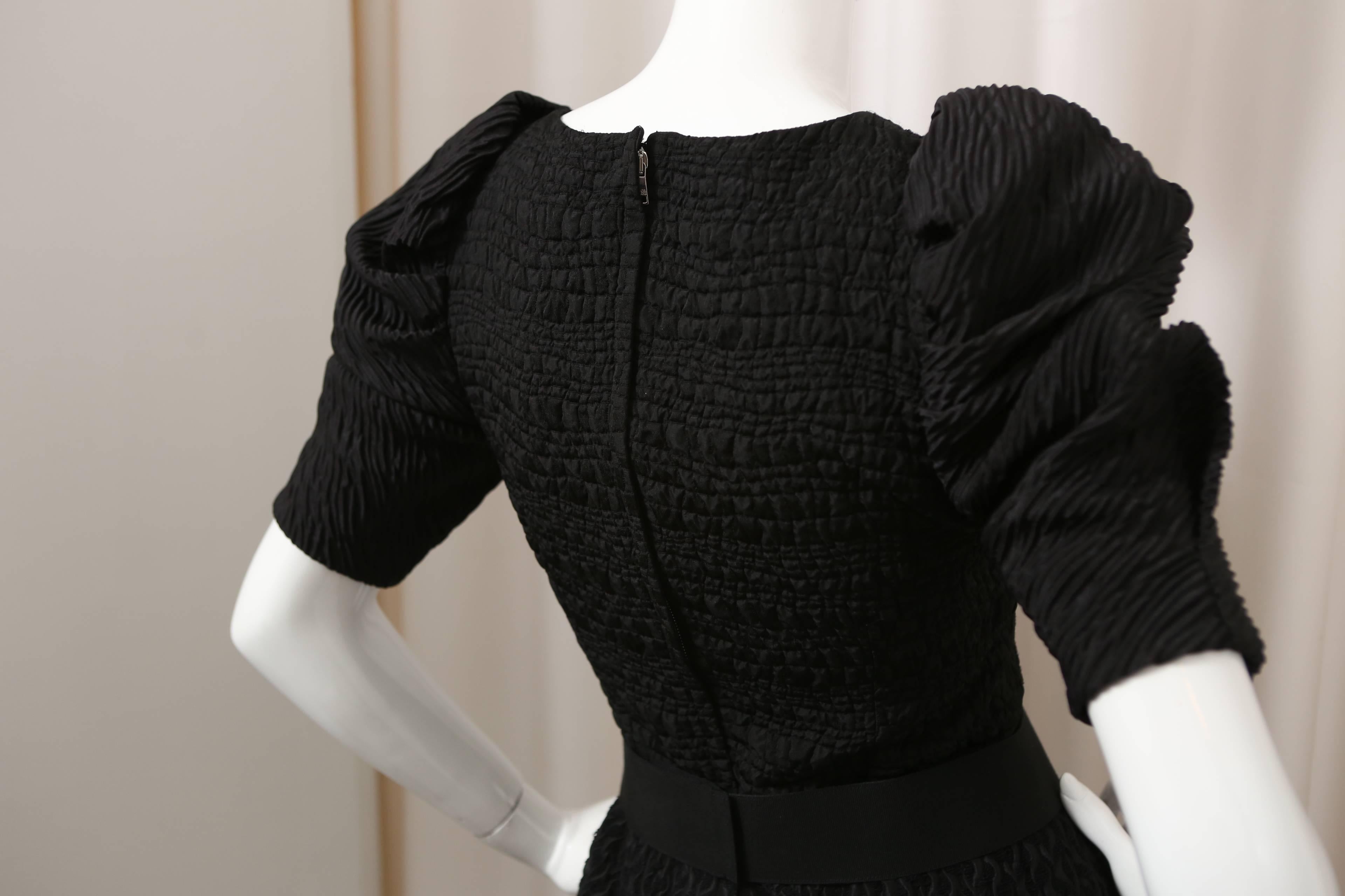 Black silk/wool blend puff-sleeve dress with attached belt.