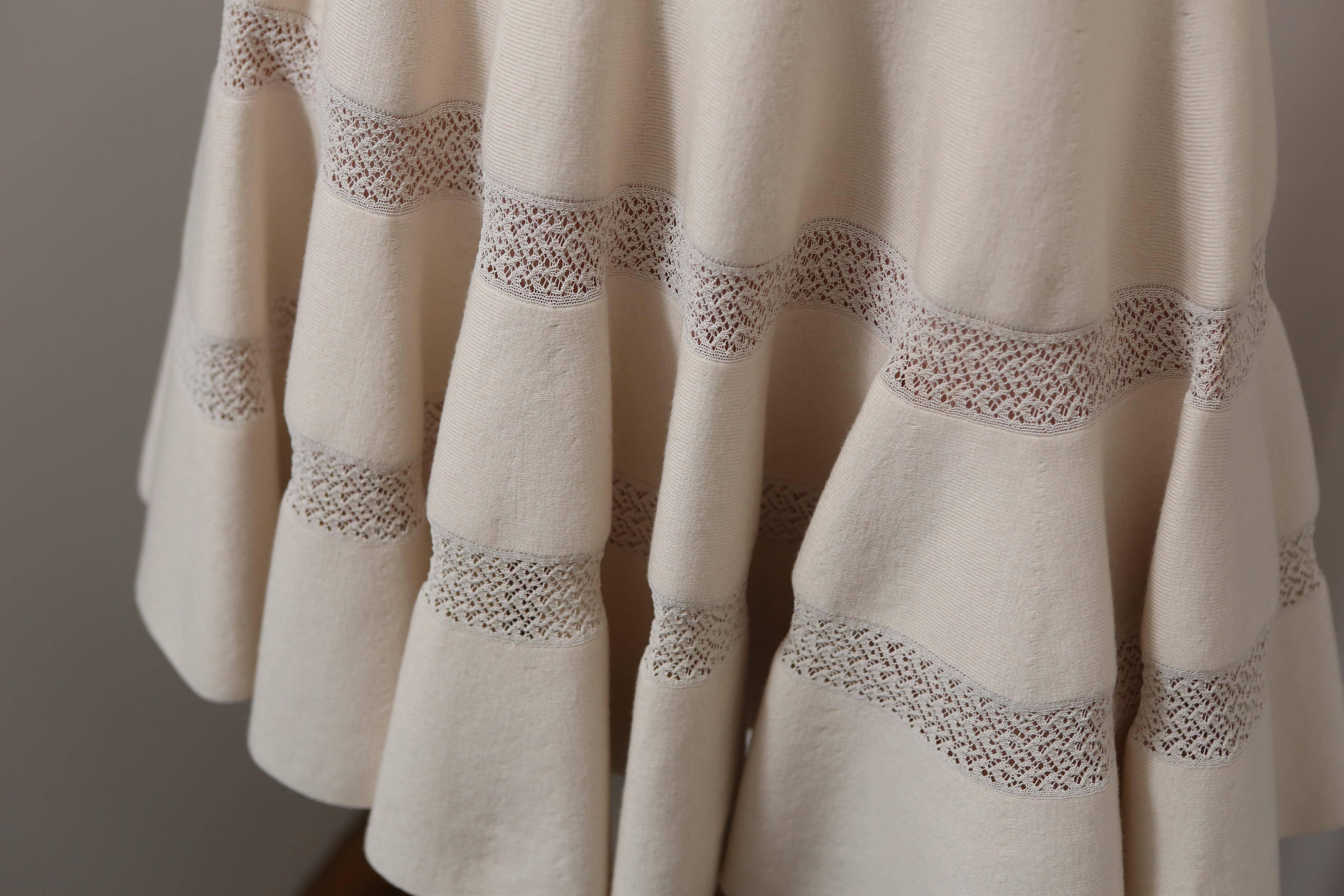 Cream knit long sleeve dress with flare skirt bottom.