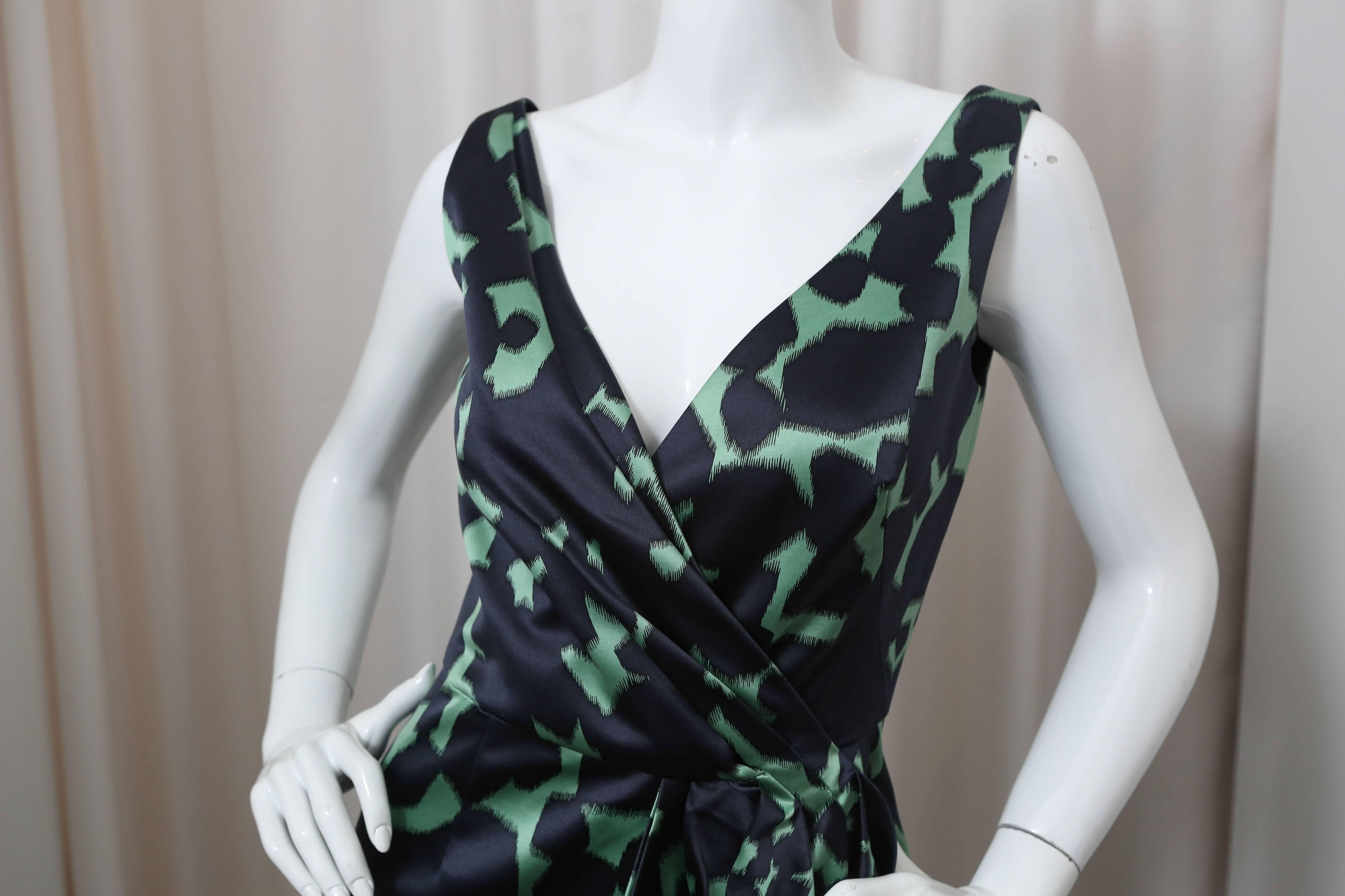 Blue silk and wool blend sleeveless v-neck faux wrap dress with green all-over printed pattern.