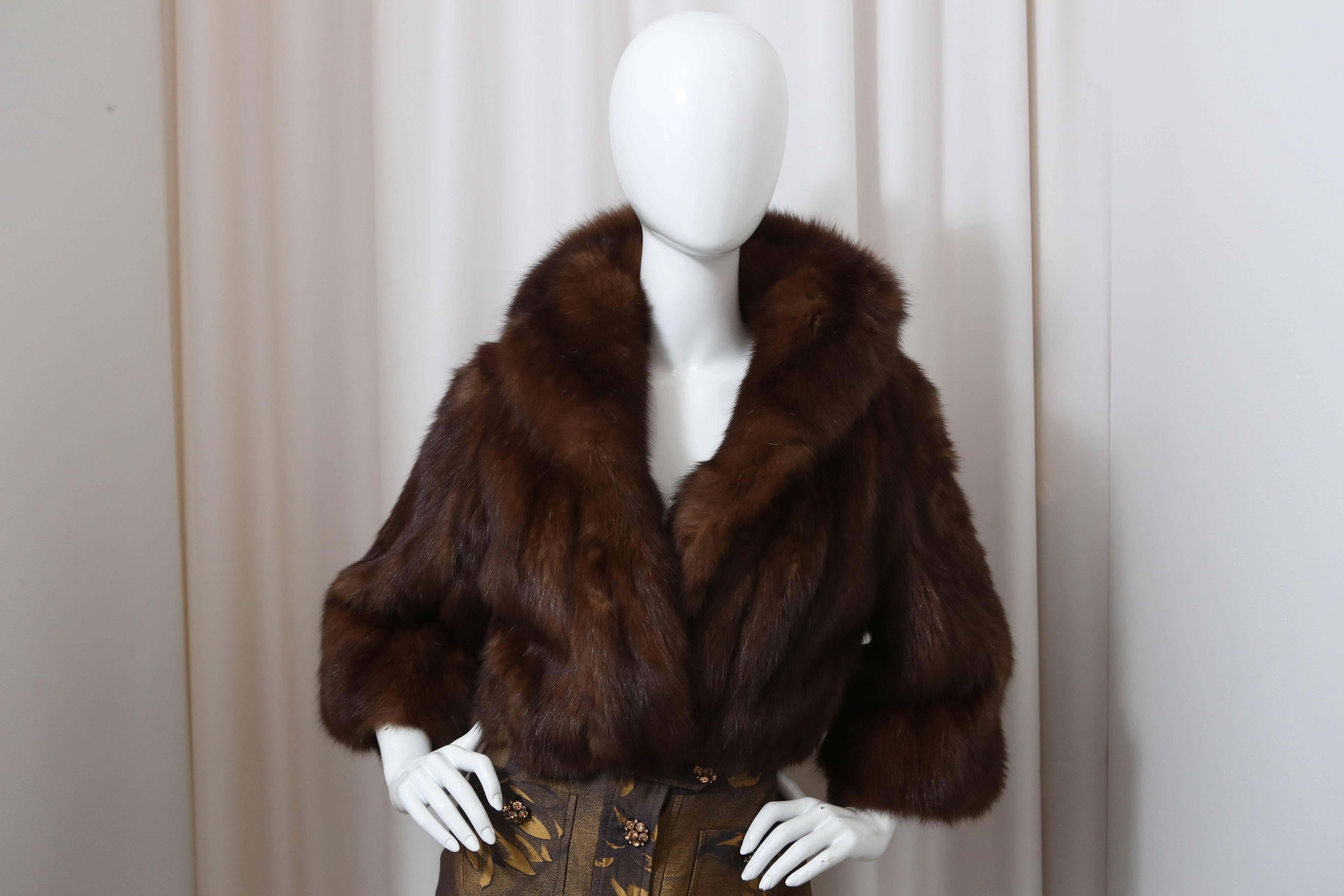 Cropped brown sable fur jacket with 3/4 sleeves and collar.