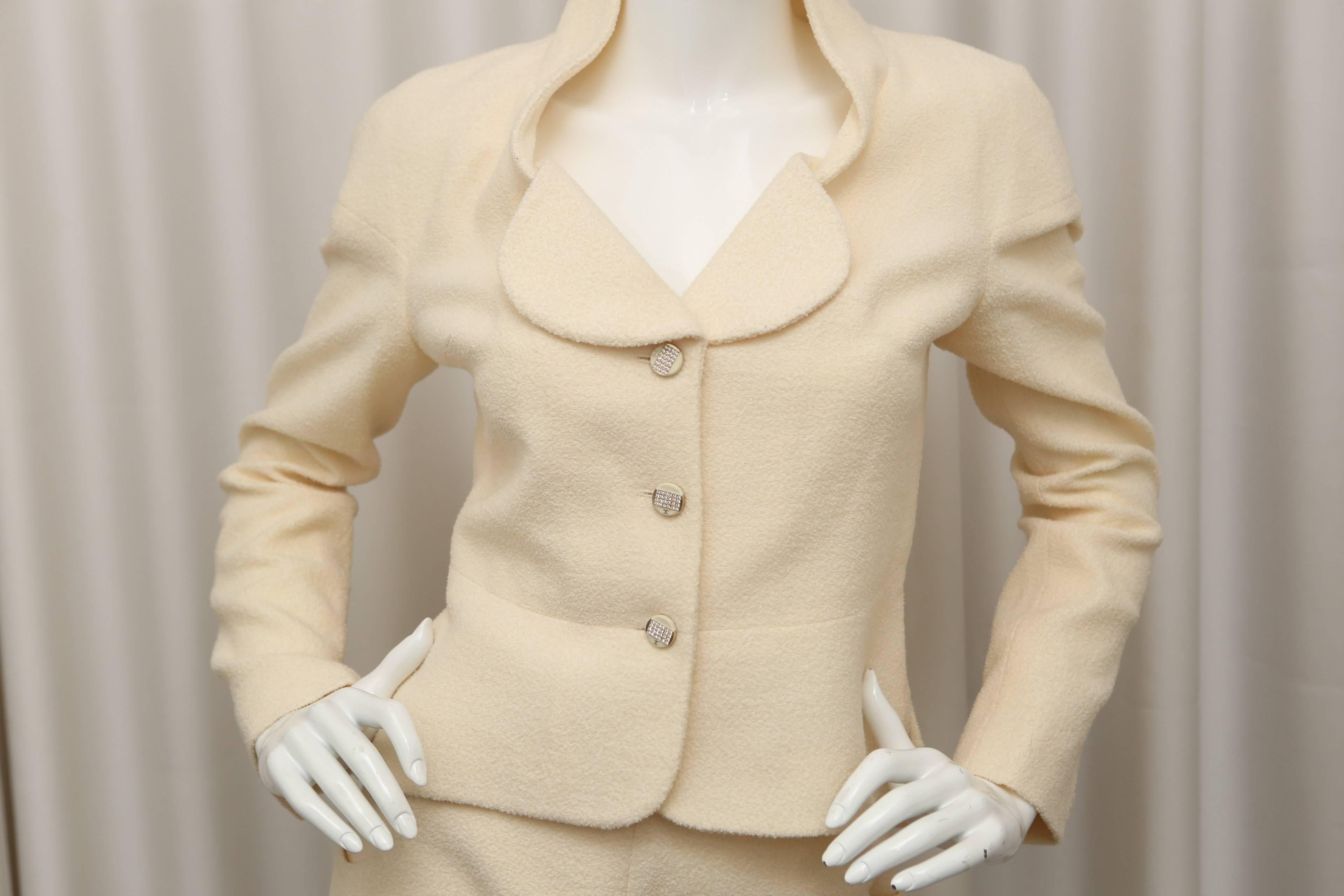 Cream 2 piece skirt suit with crystal detailed buttons.