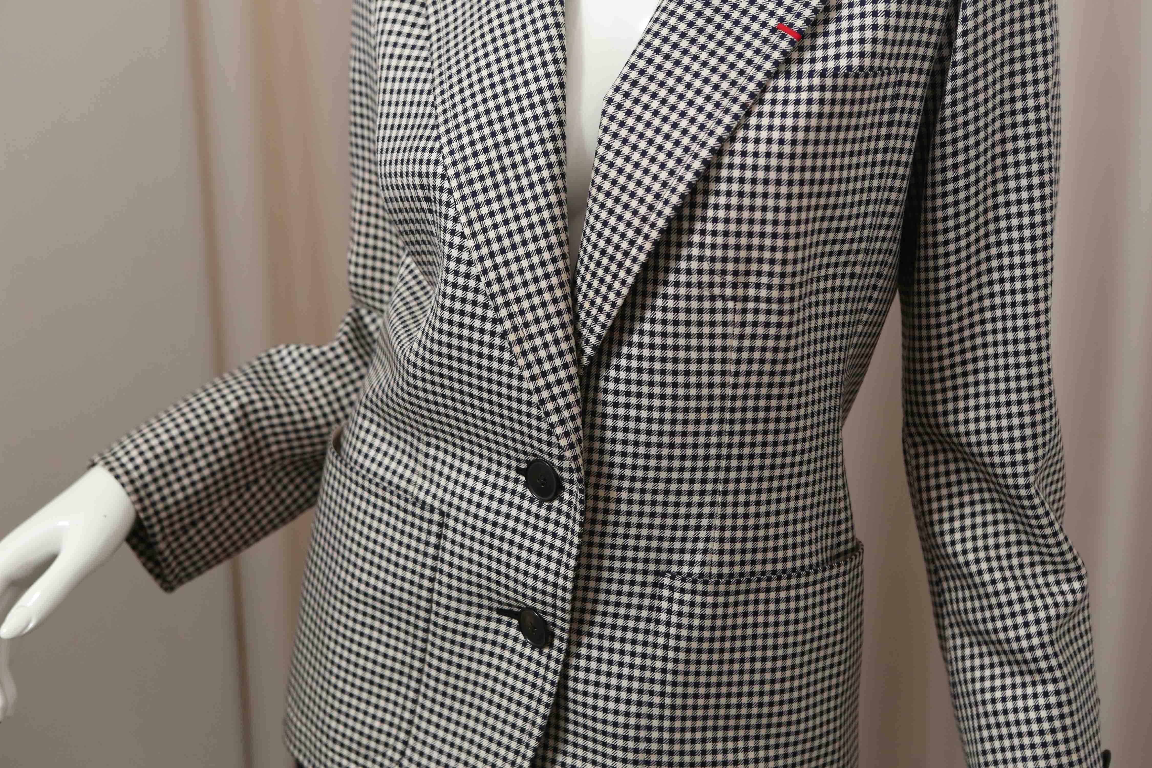 Black and white houndstooth blazer with front pockets, cotton/wool blend.