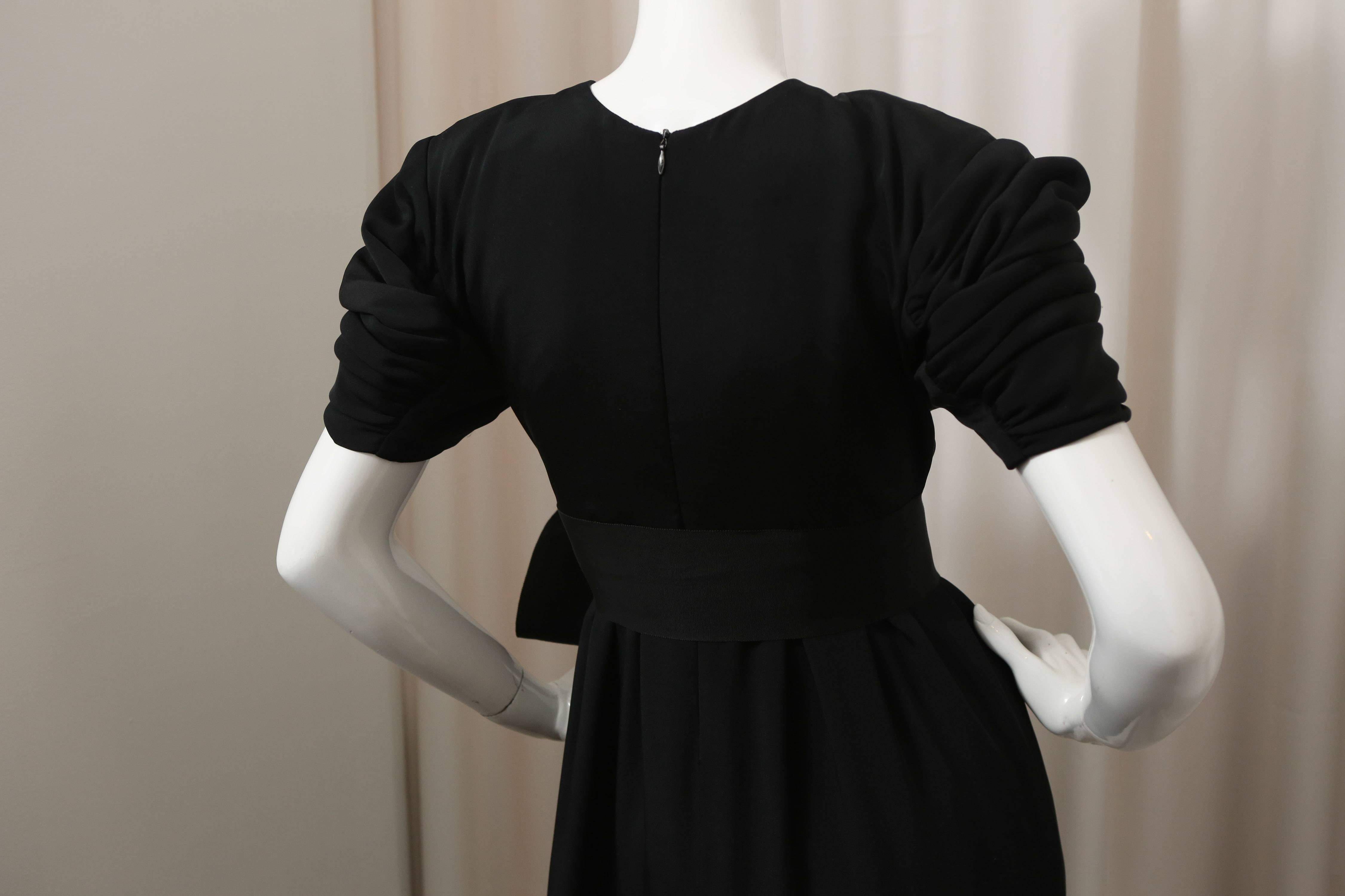 Black puff sleeve, wide leg jumpsuit with belt and side pockets.