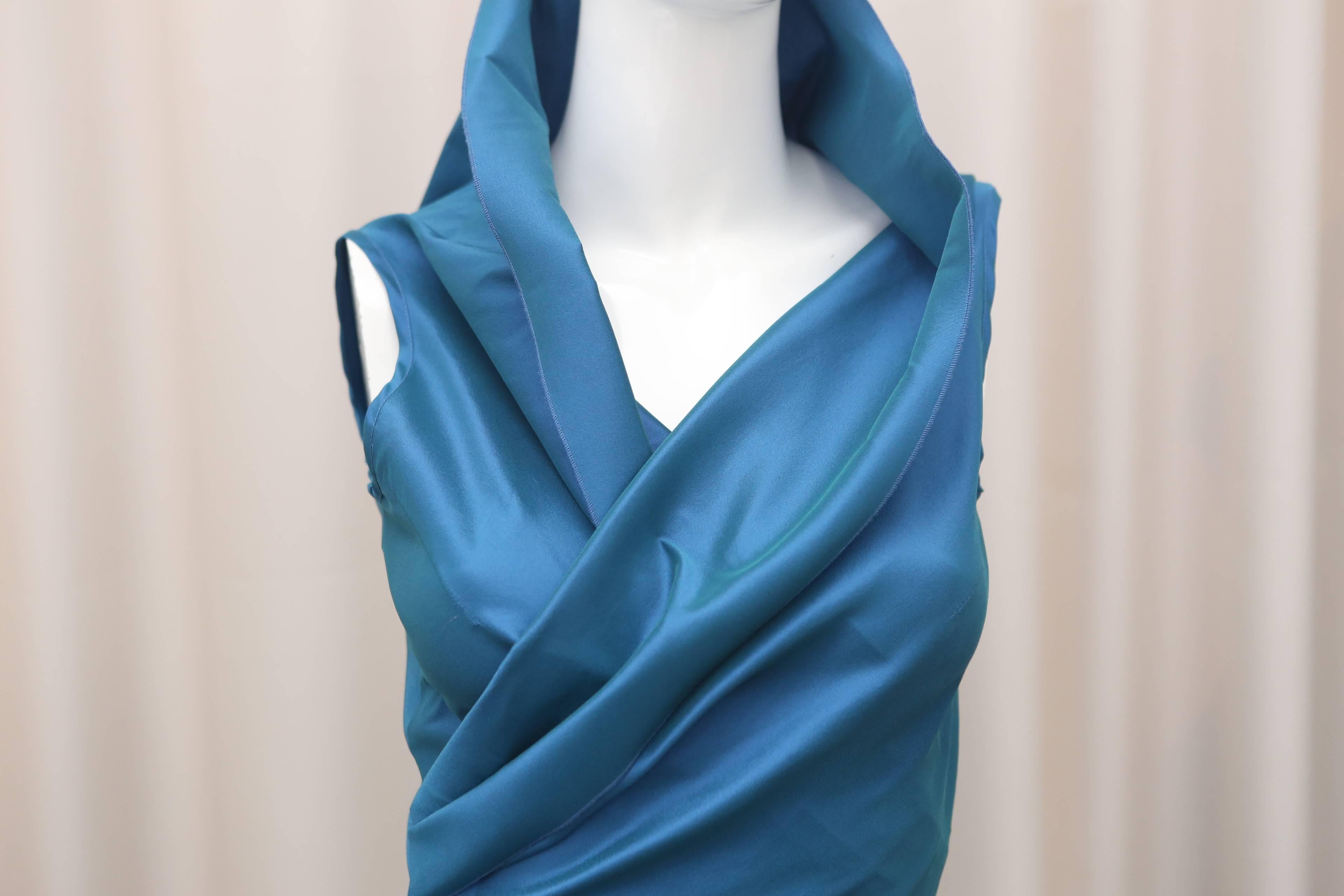 Talbot Runhof sleeveless blue faux-wrap dress.  Slightly irredescent with moveable collar and ruching on back.  

Size not marked, estimated US 2.

58% Polyester
28% Silk
13% Nylon
1% Elastane