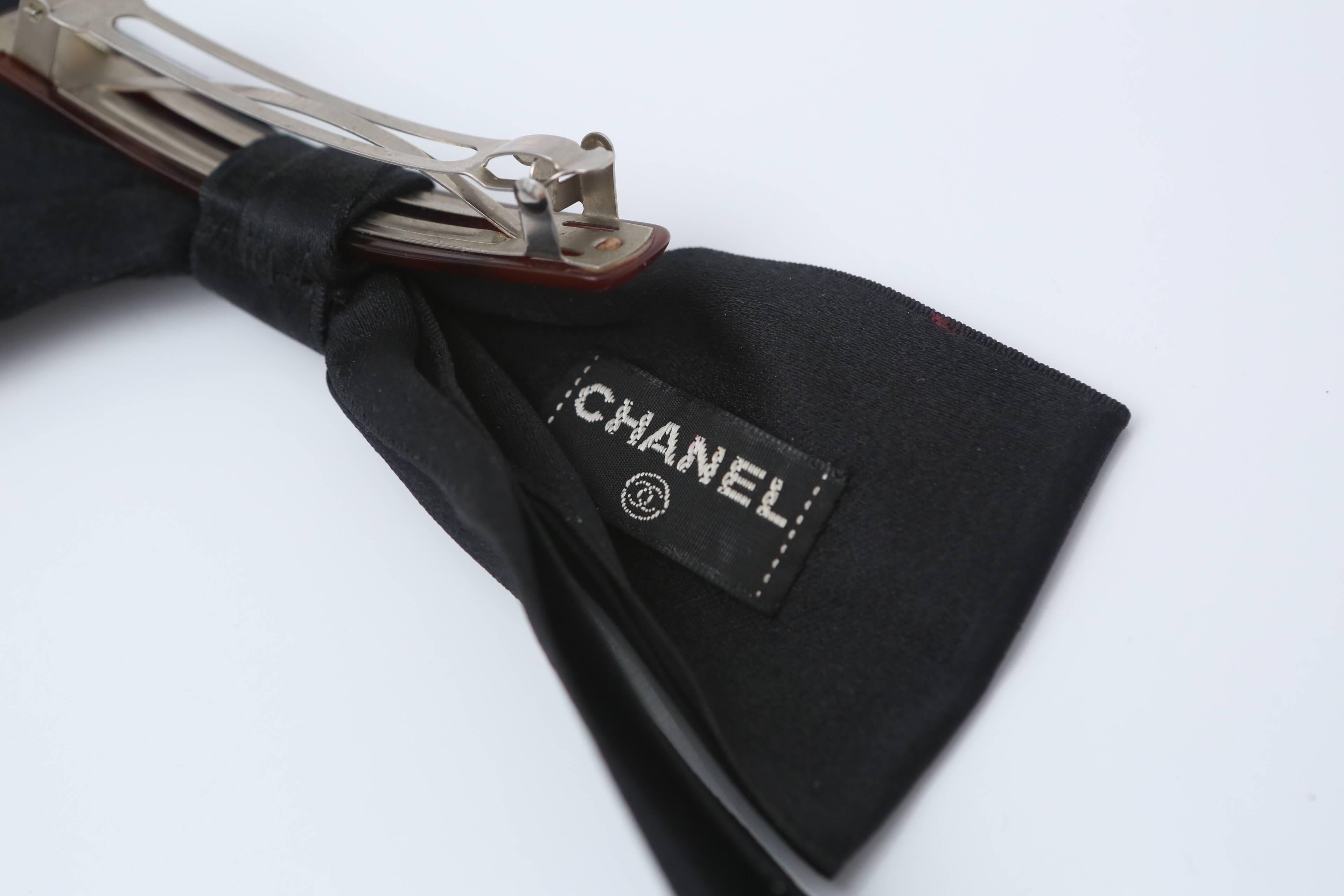 Chanel black large hair bow with attached barrette.  

Barrette is 3.5