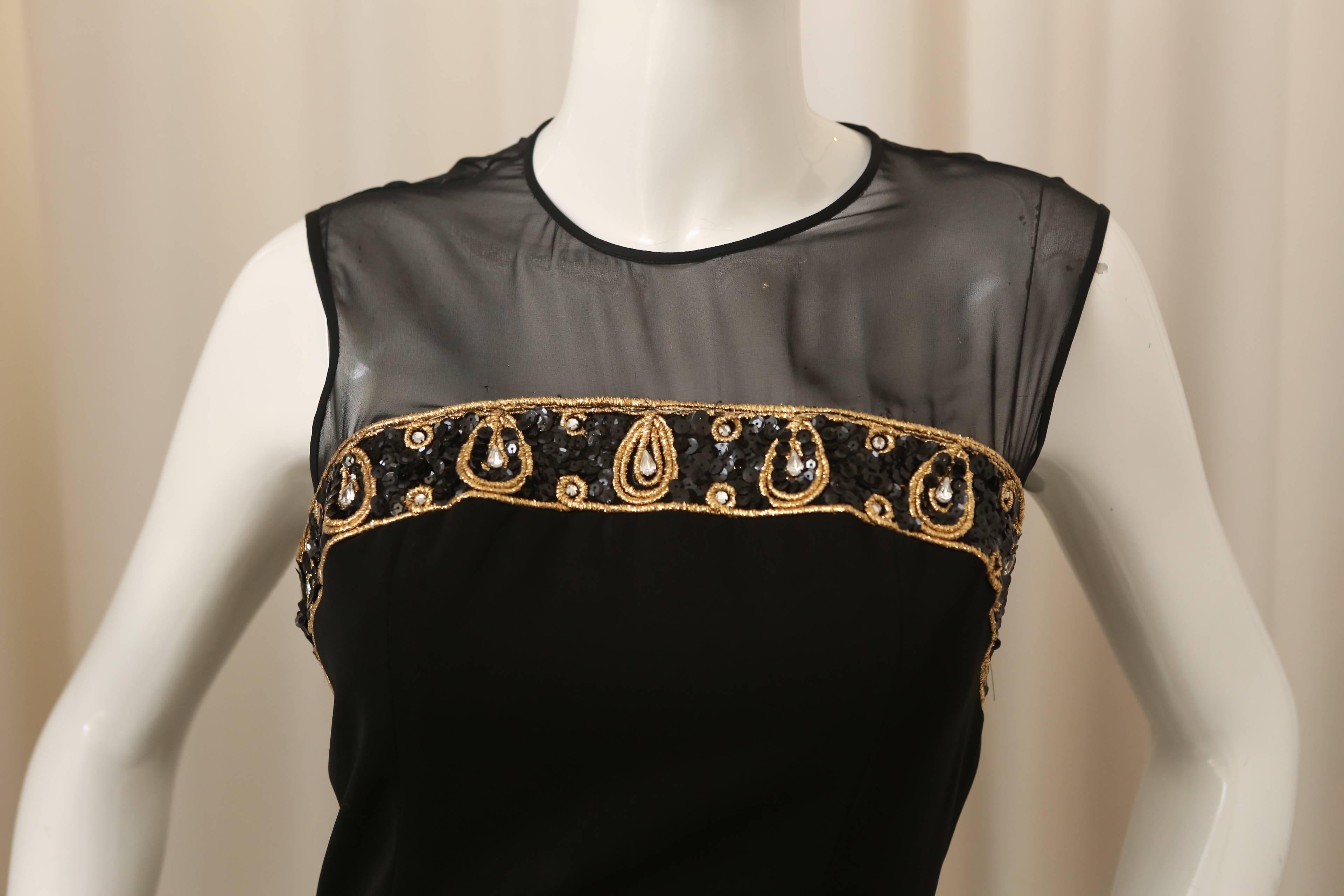 CD de Christian Dior black/gold sleeveless dress with mesh detail and embellishment.  Sequin bow detail in the back. Button closure.